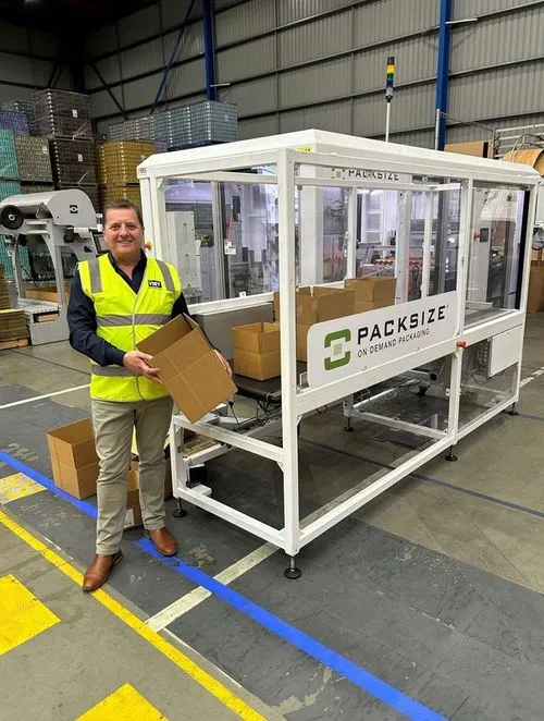 A Packsize employee near an X5 automated packaging machine in Australia with Visy