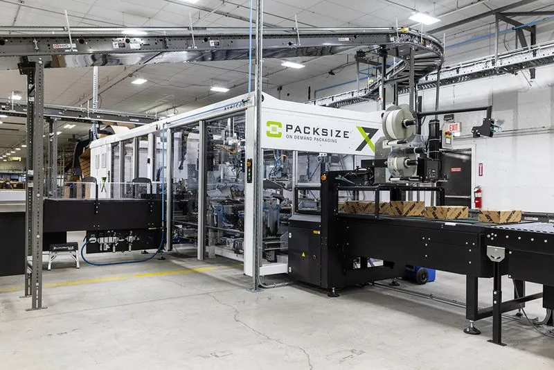 A photo of the Packsize X7 automated packaging machine in action at Boot Barn.