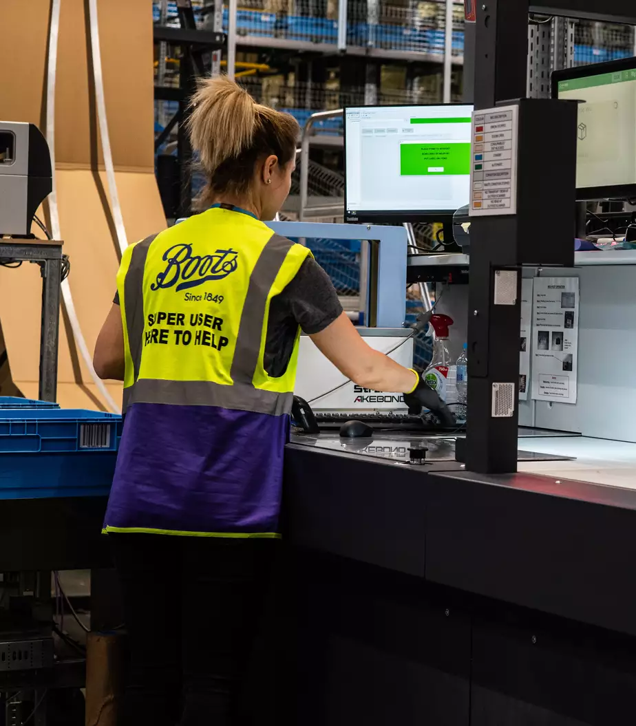 Boots items arranged and packed at a packaging table.