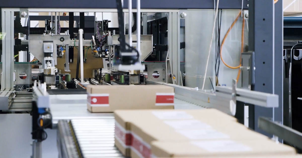 Custom packaged boxes exiting packaging machine