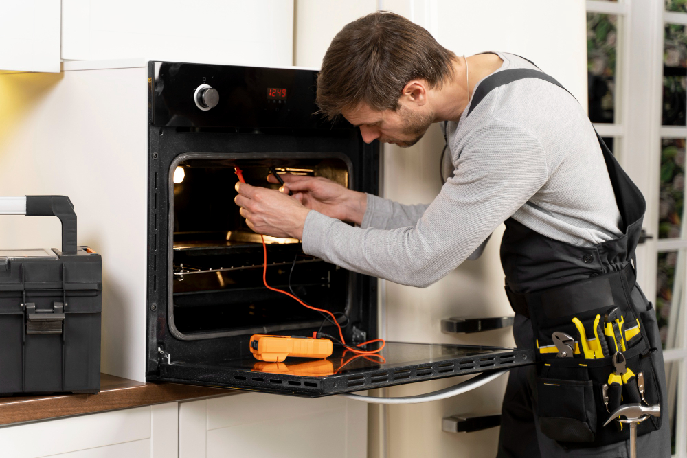 `Technician testing an oven with a multimeter during a repair`
