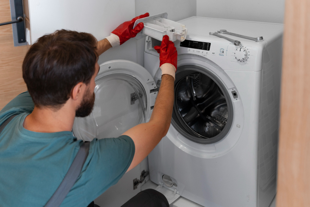 Technician replacing a washing machine door seal