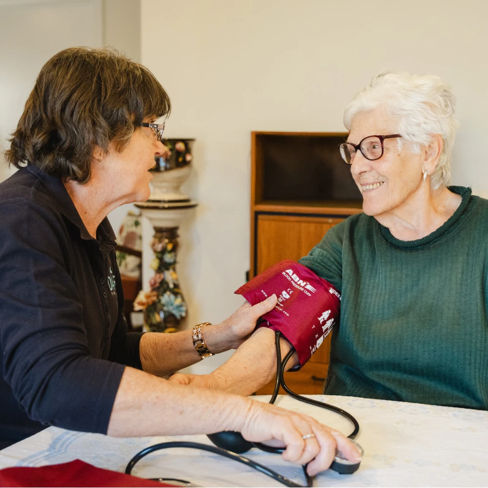 Registered Nurse taking blood pressure of elderly client