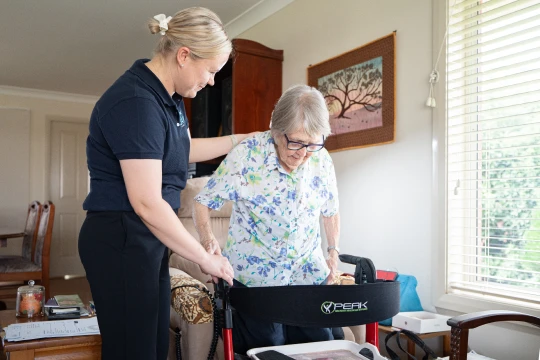 Registered Nurse helping a client with mobility