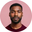 A man with a beard and a red shirt.