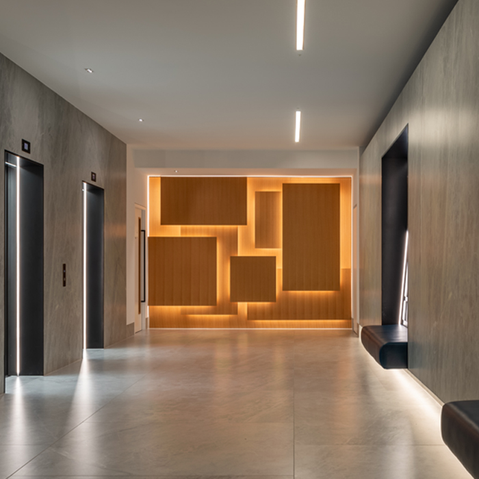 Abstract wavy lines gradient in yellow and orange on a soft blue-gray background.