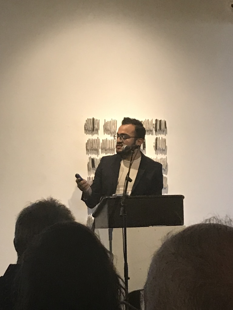 Alexander Lozano speaking at arts funding event — grant writing services by Cardoza LLC