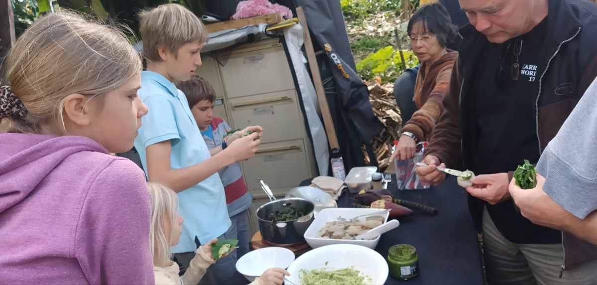 Children and adults preparing and sharing edible plants together at Ediblescapes during Botanical Bazaar 2025