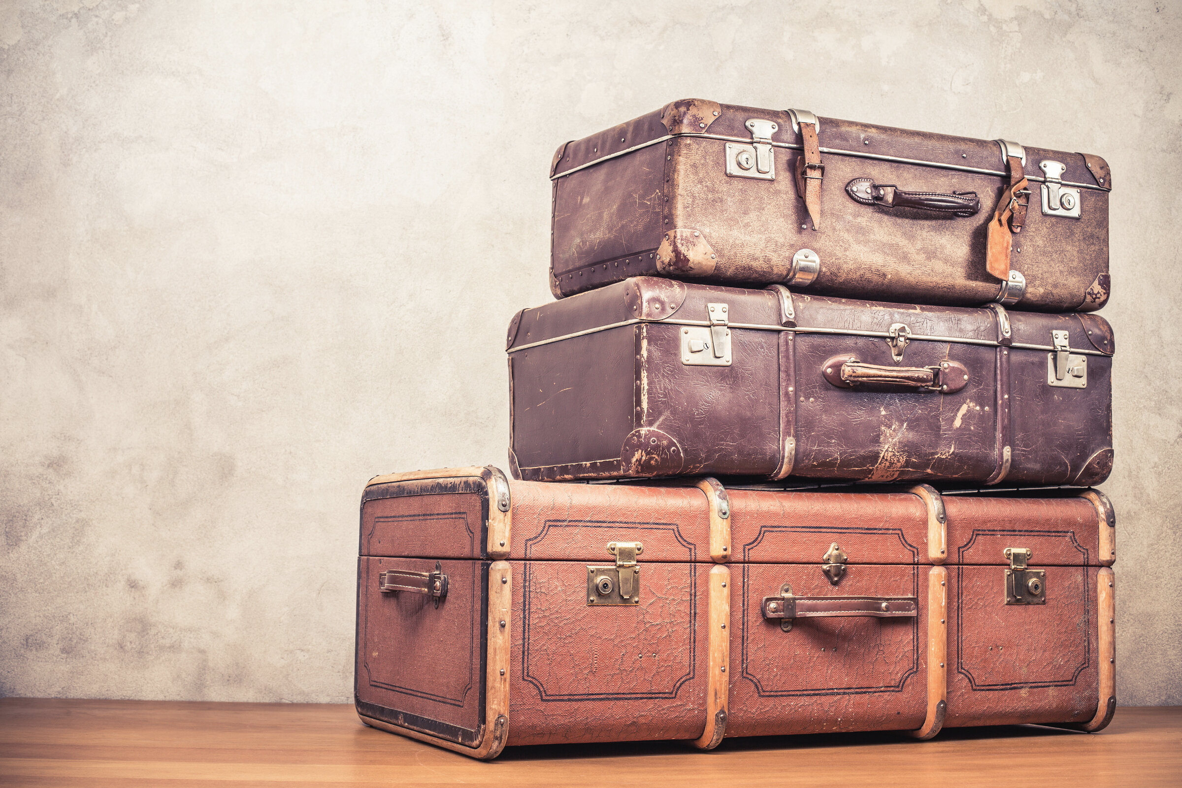 Stack of vintage leather travel suitcases evoking classic European journeys