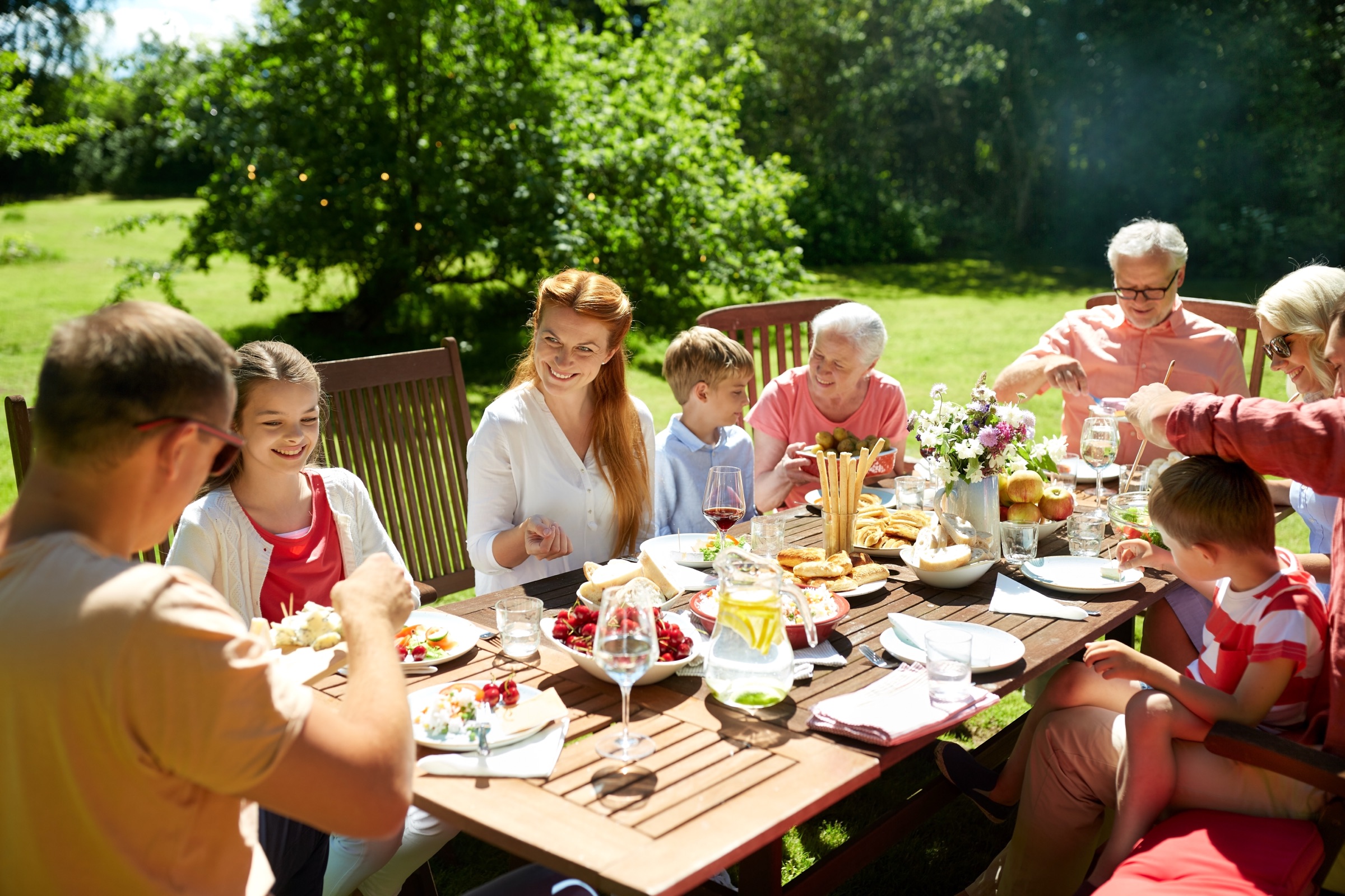 A family sharing dinner in a summer garden