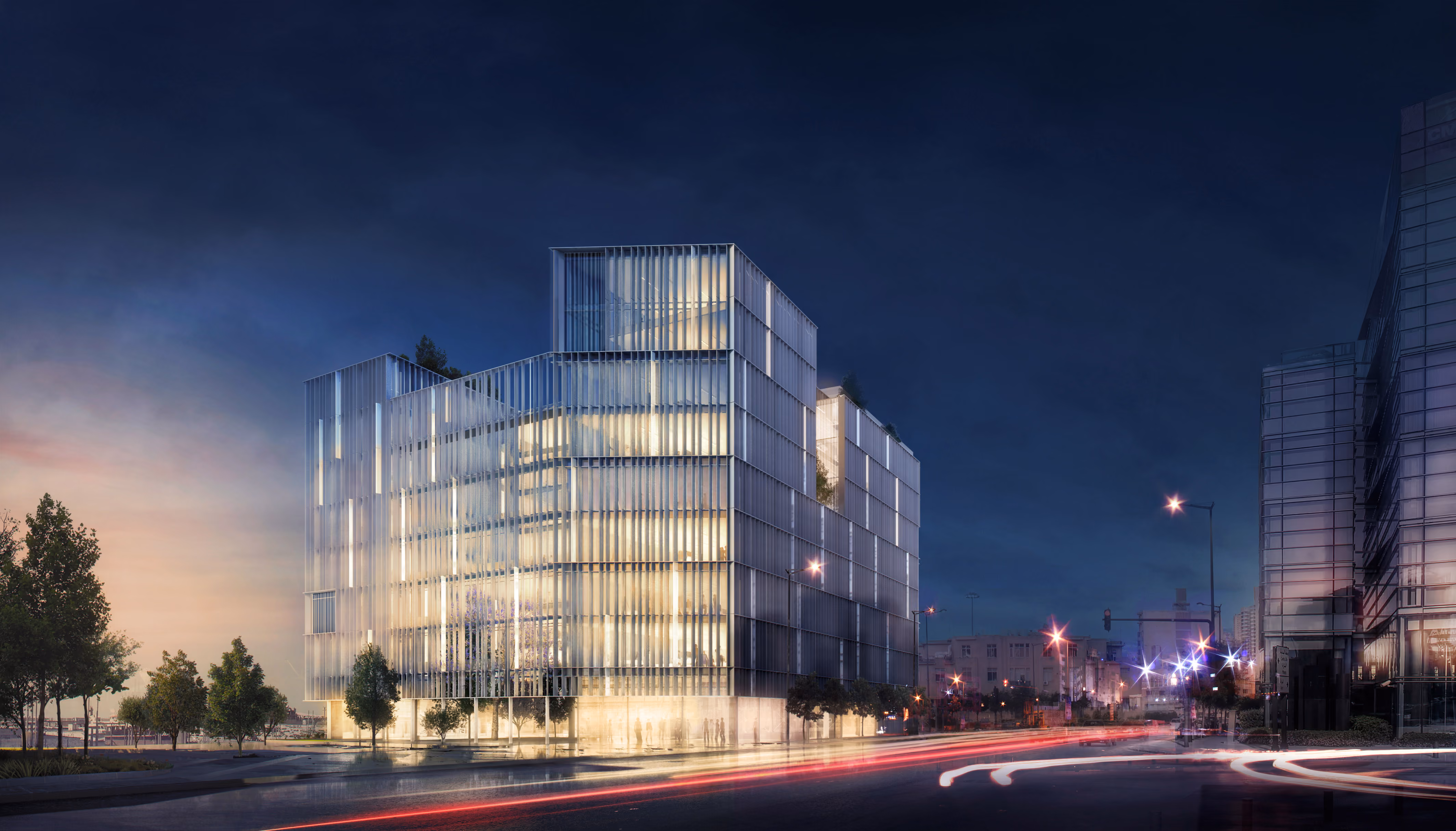 Night view of Marfaa 1506 in Beirut, a stacked glass volume with vertical fin louvres glowing from within above a street with light trails