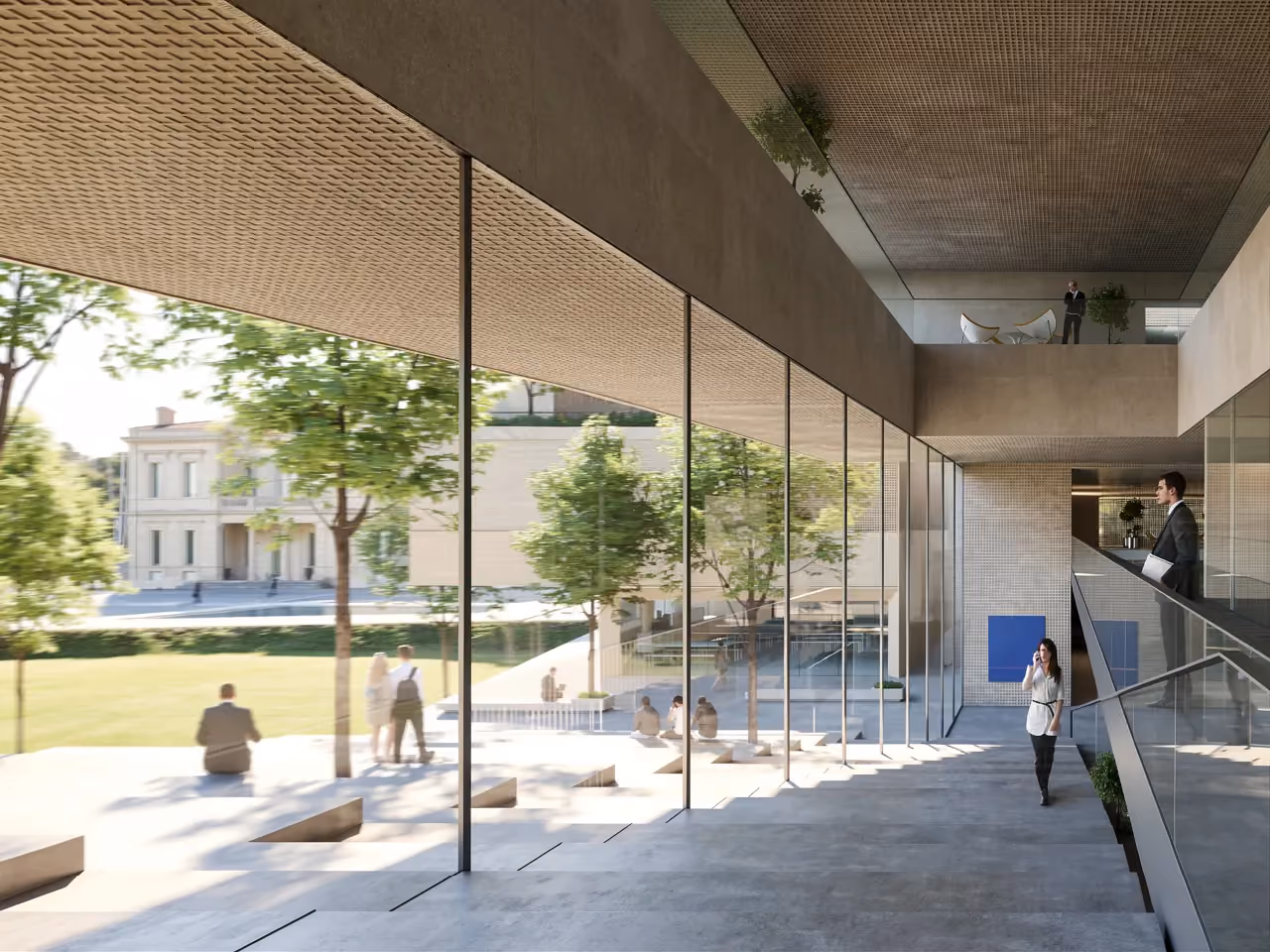 Glazed corridor of the Corporate Academy in Marseille overlooking a landscaped courtyard with trees, seating, and a historic building beyond