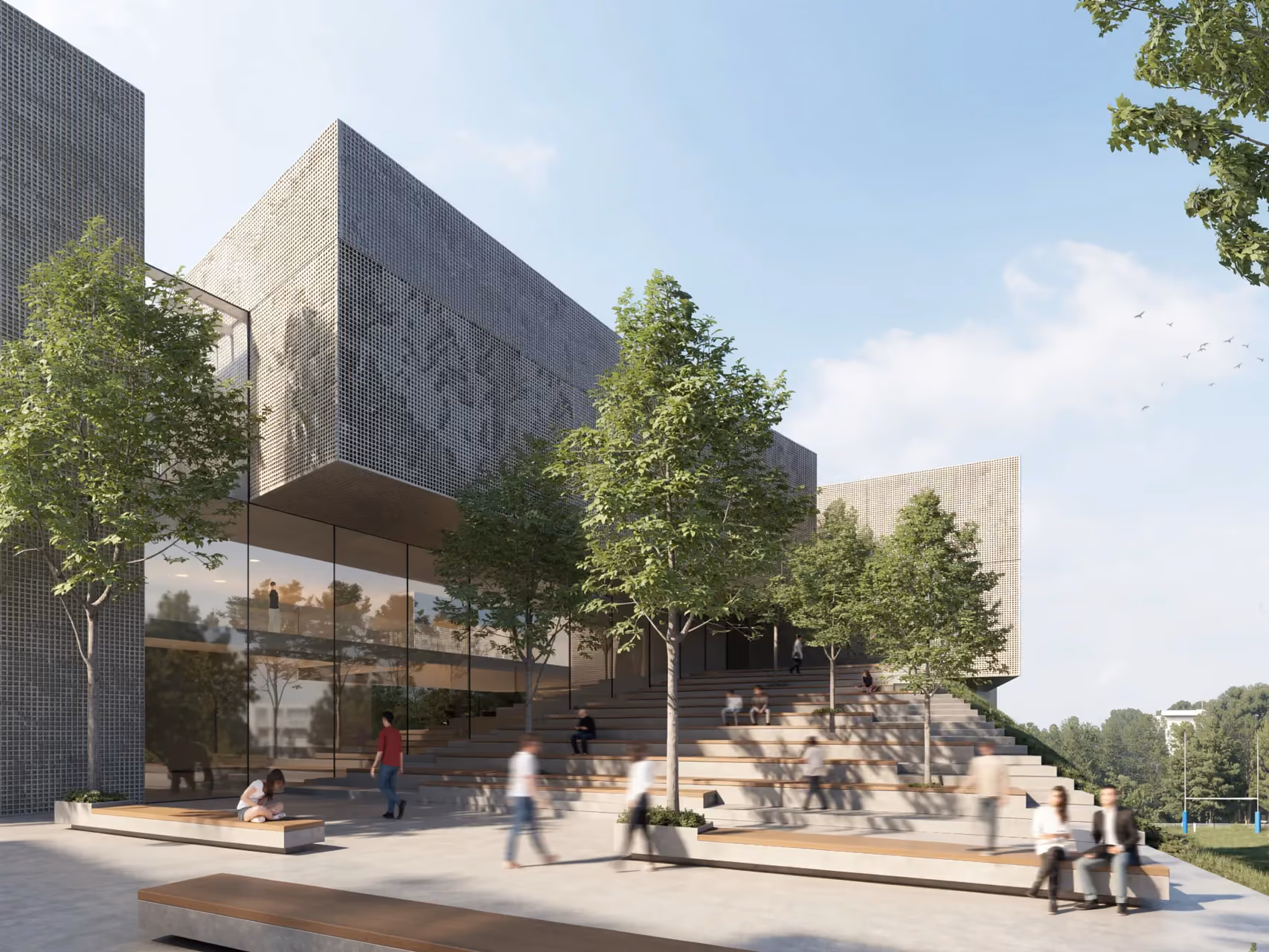Perforated stone-clad volumes of the corporate academy in Marseille rise above a tiered outdoor amphitheatre with trees and people gathering on the steps