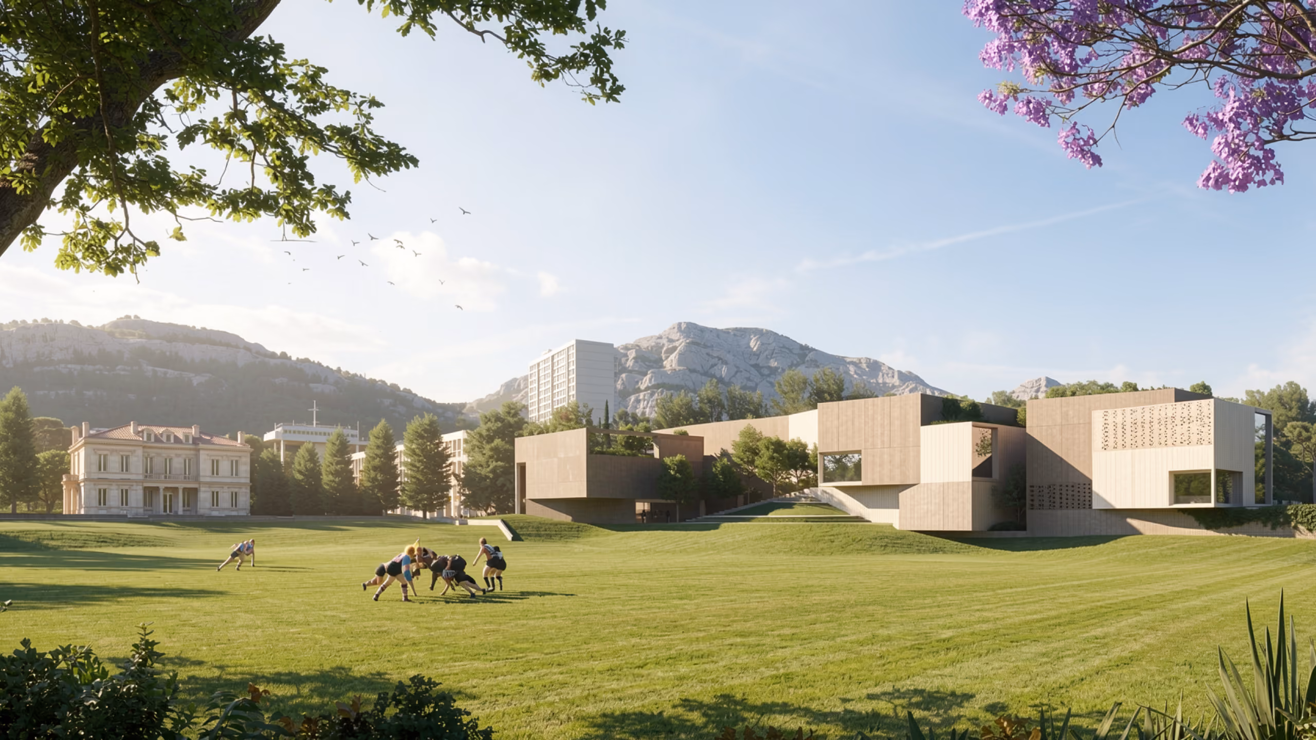 Corporate Academy in Marseille, angular limestone-clad buildings set into a grassy slope, with a historic villa and rugby players on the lawn beyond