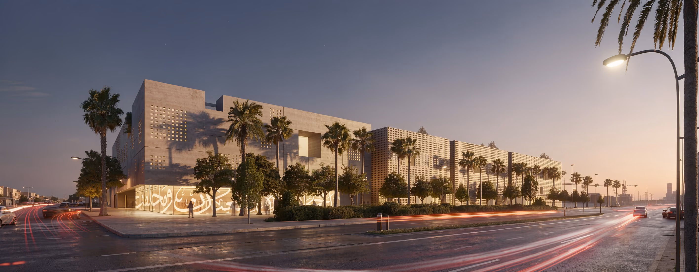 Art Oasis in Riyadh at dusk, perforated concrete facade with Arabic calligraphy screen, palm trees lining the street as car light trails pass by