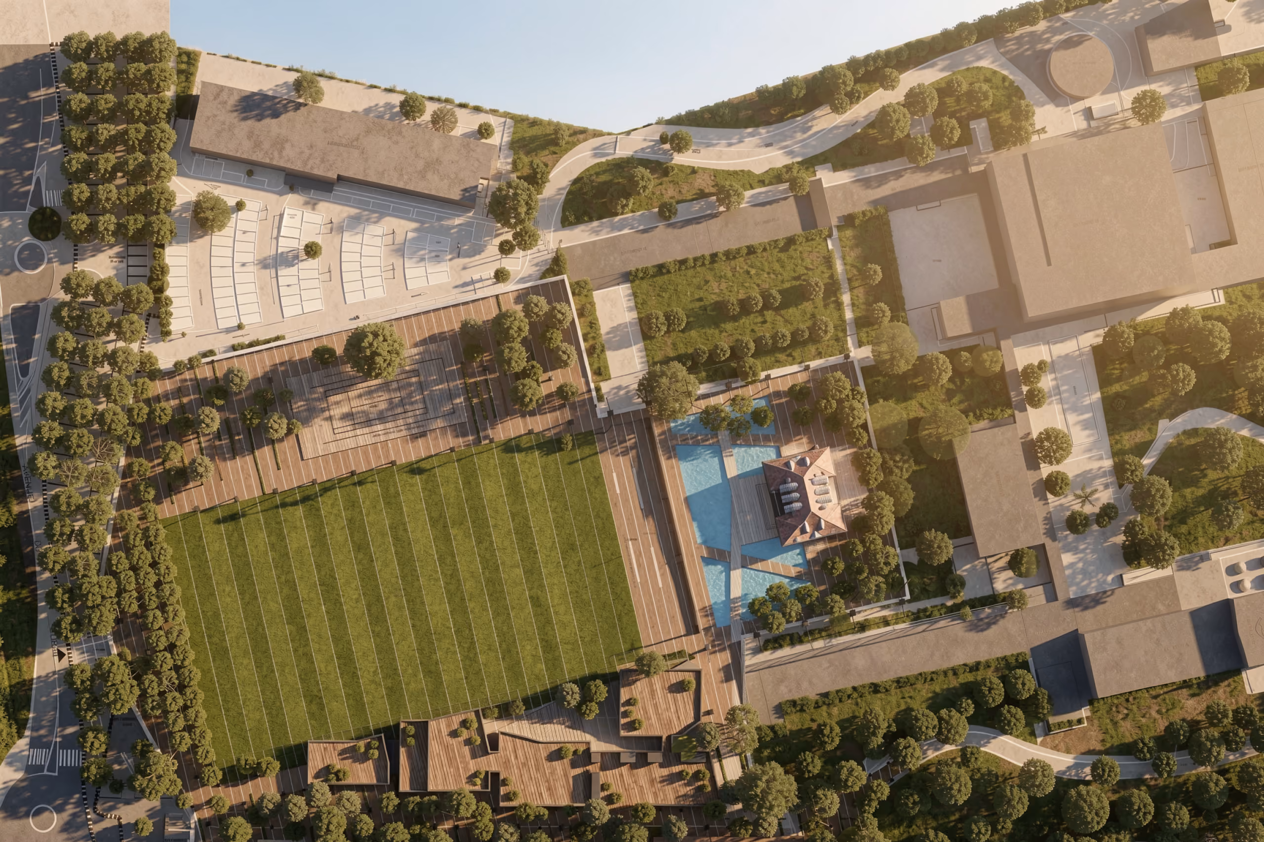 Aerial view of the corporate academy in Marseille, showing a running track, sports field, swimming pool, tree-lined pathways and surrounding low-rise buildings