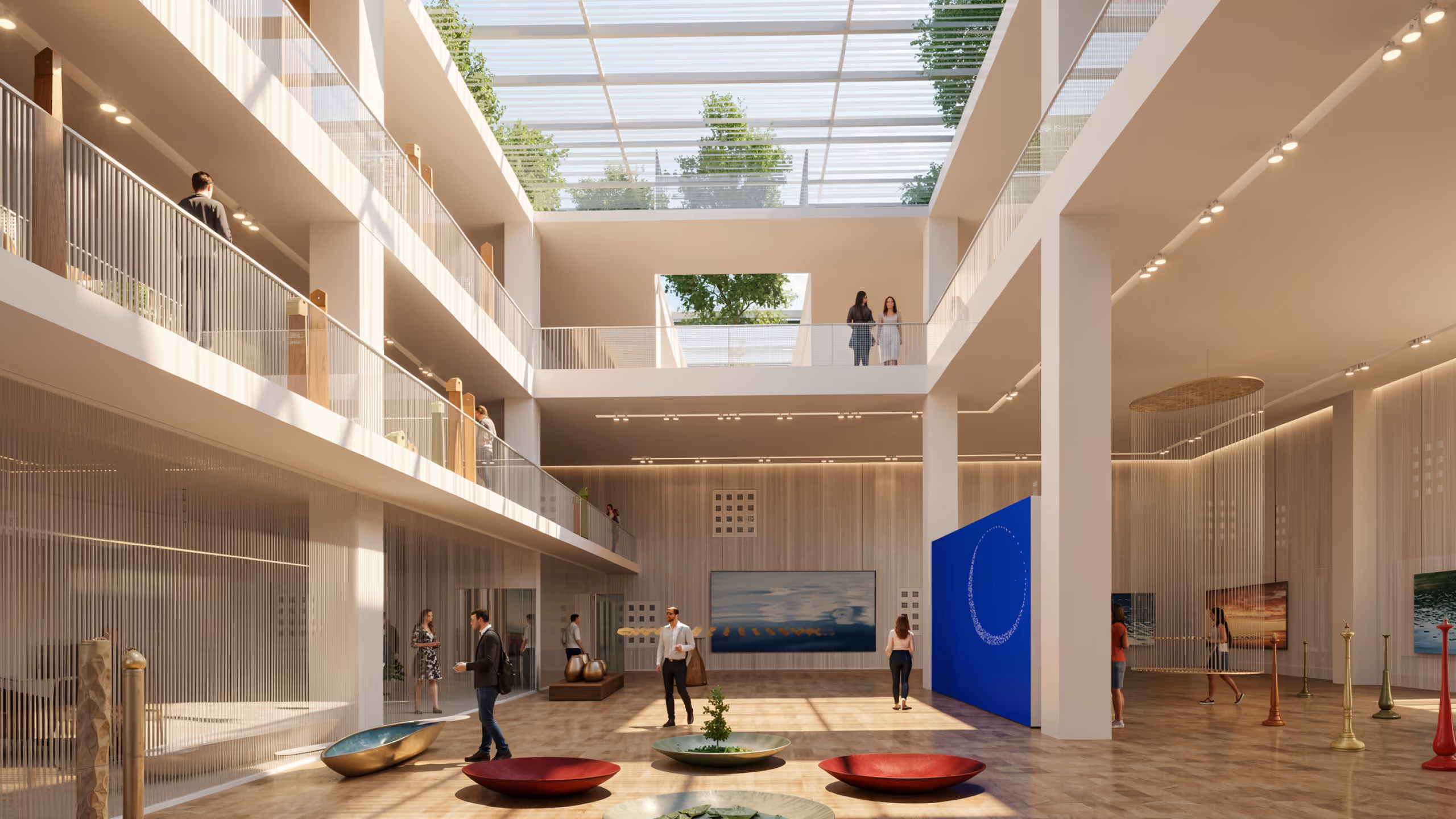 Multi-storey atrium of Art Oasis in Riyadh, visitors on tiered balconies beneath a glazed skylight above a ground-floor gallery with sculptures and artwork
