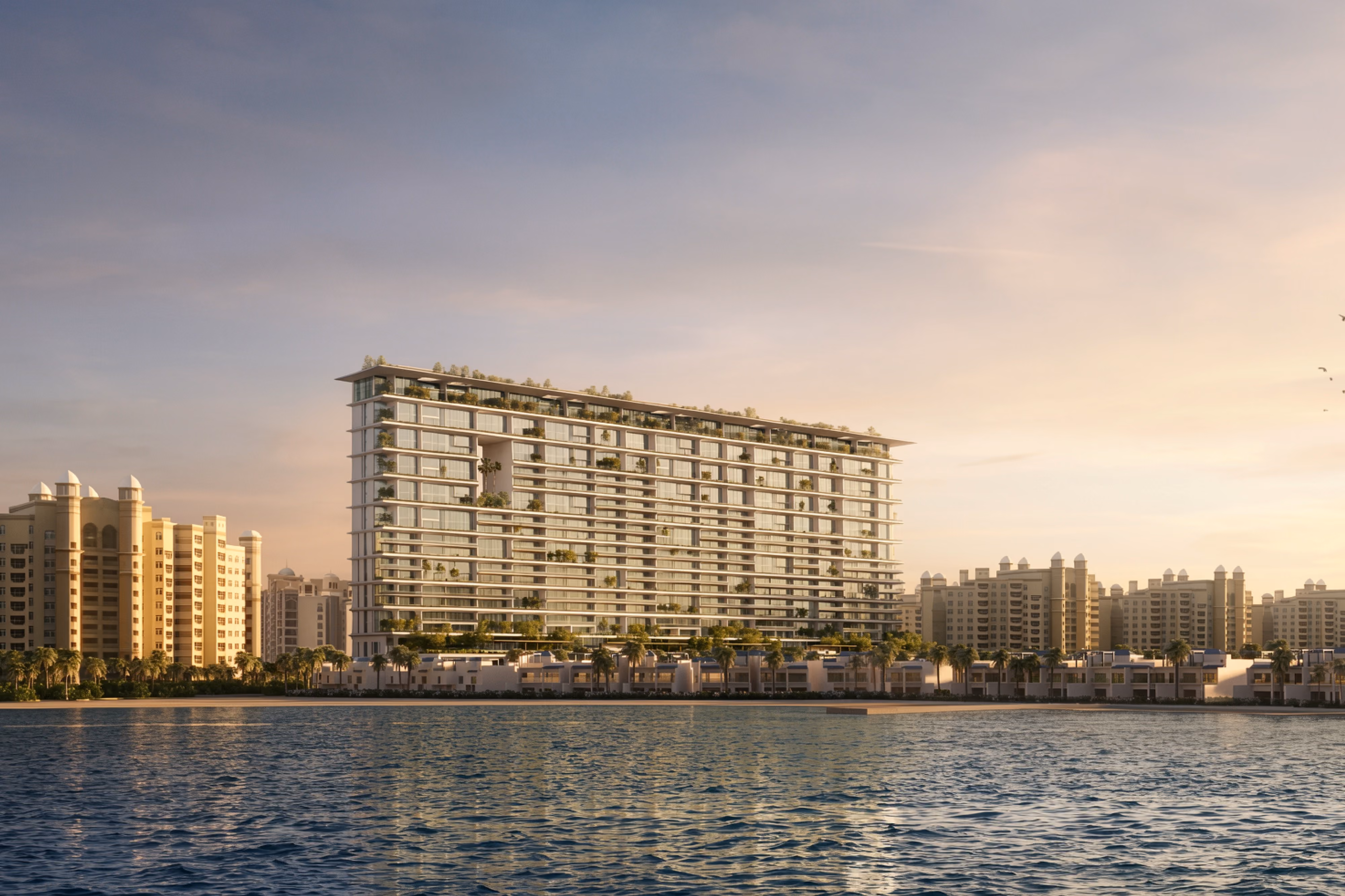 Skylife, a terraced residential tower with lush planted balconies by Nabil Gholam Architects, standing along the waterfront of Palm Beach Jumeirah, Dubai, United Arab Emirates