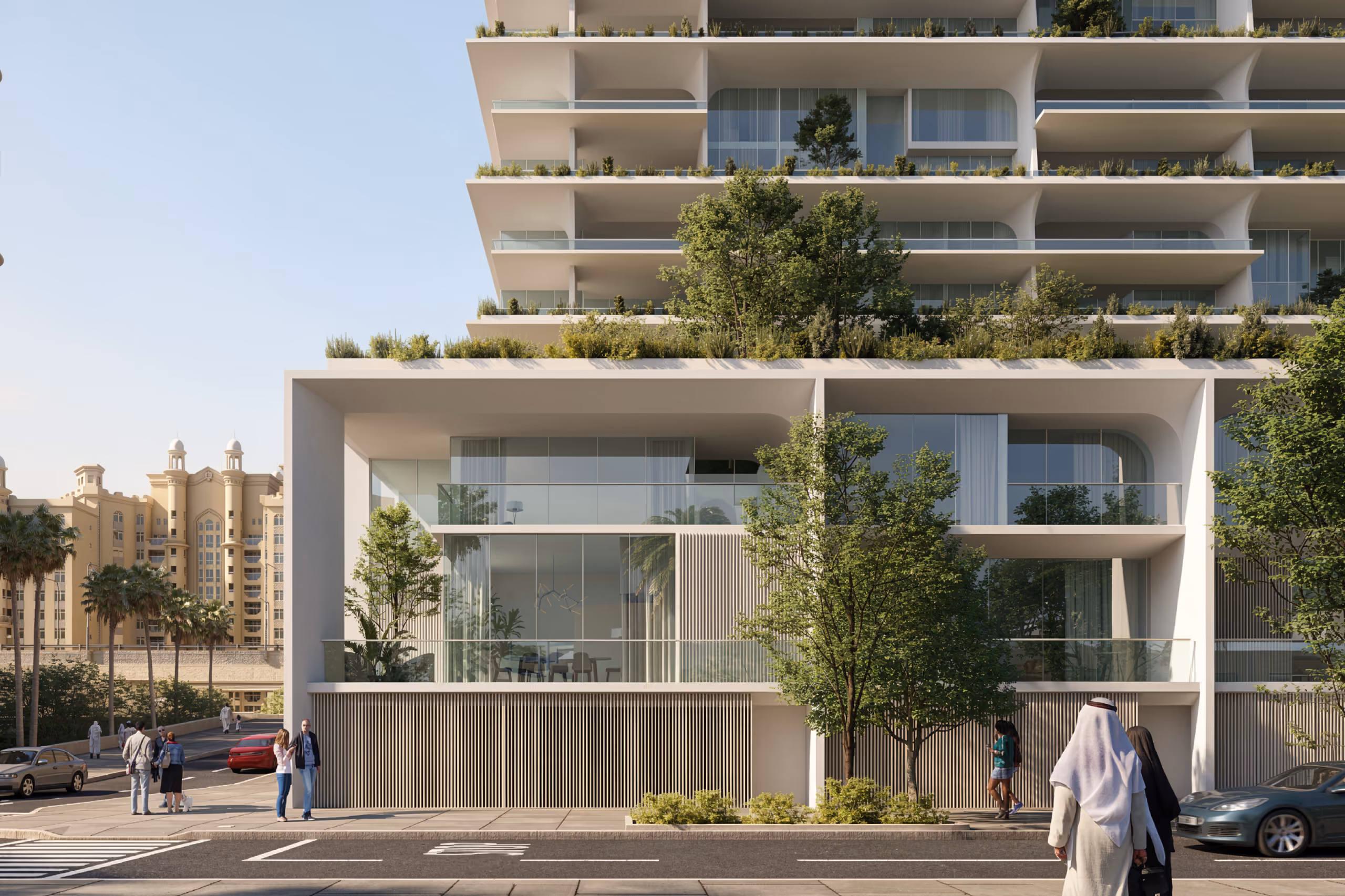 Street-level view of Skylife in Dubai, ground-floor units with glazed facades and timber louvres, terraces above layered with hanging greenery