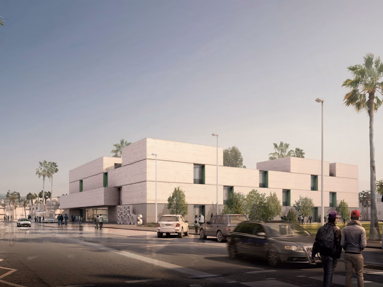 Street-level view of Babel Schools in Babel, a stacked concrete volume with green-framed windows, palm trees and pedestrians along the roadside