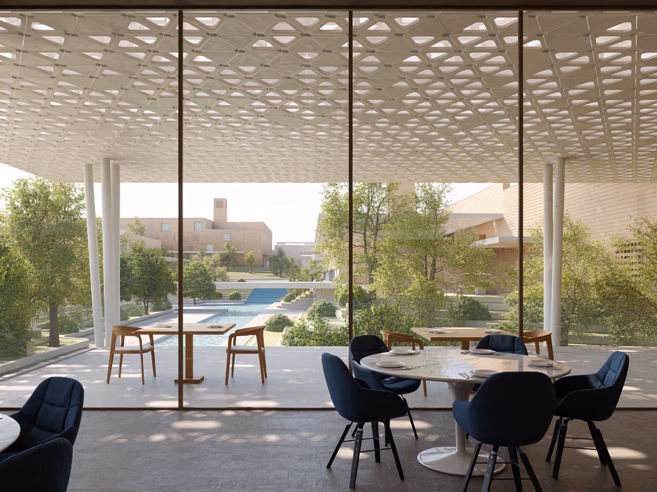 Dining terrace at Green Office Park with a perforated white canopy, navy chairs and marble tables overlooking a pool and landscaped courtyard