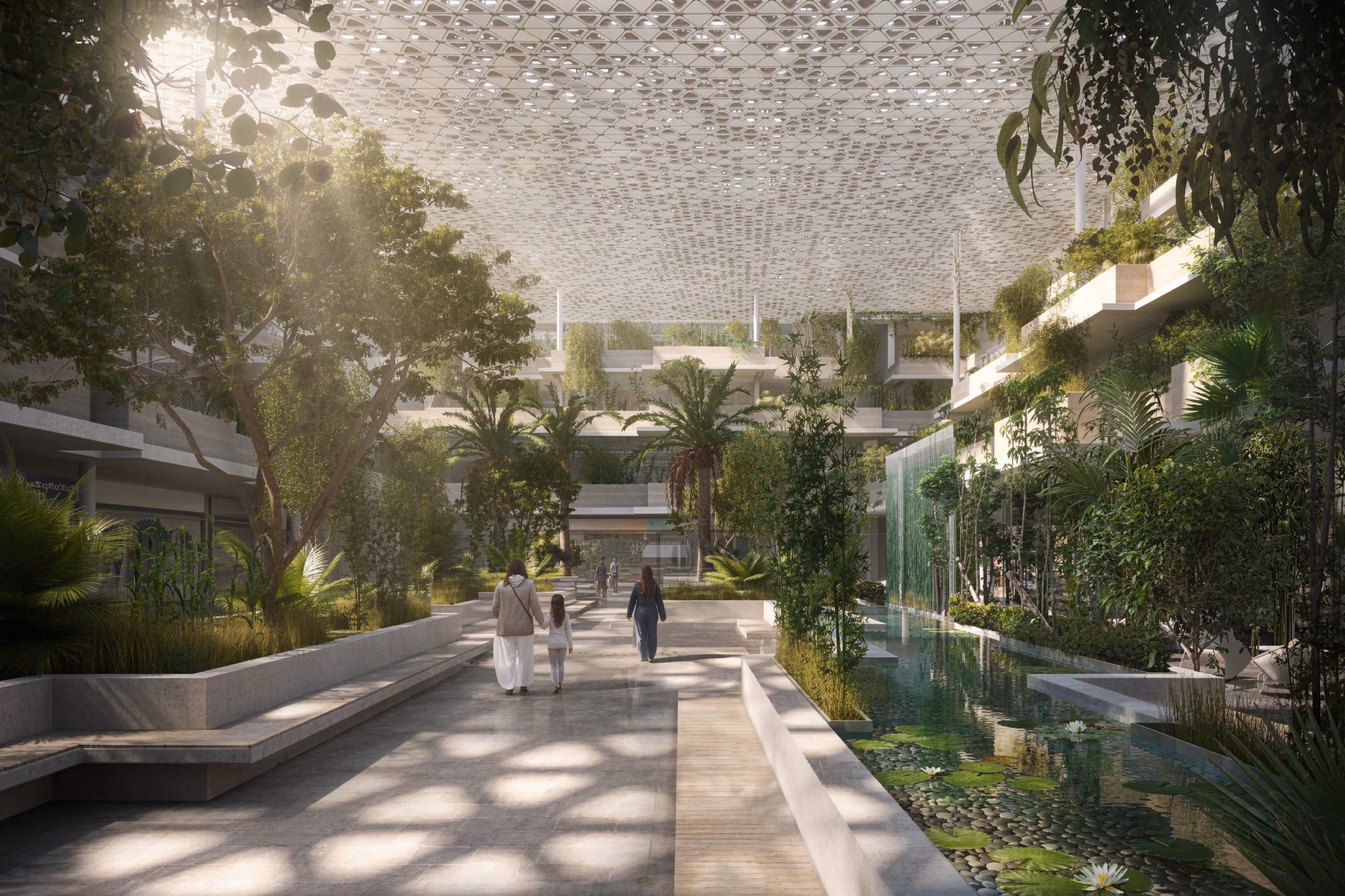 Interior courtyard of Green Office Park with a landscaped walkway, reflecting pool and lily pads beneath a perforated shading canopy filtering sunlight through dense greenery