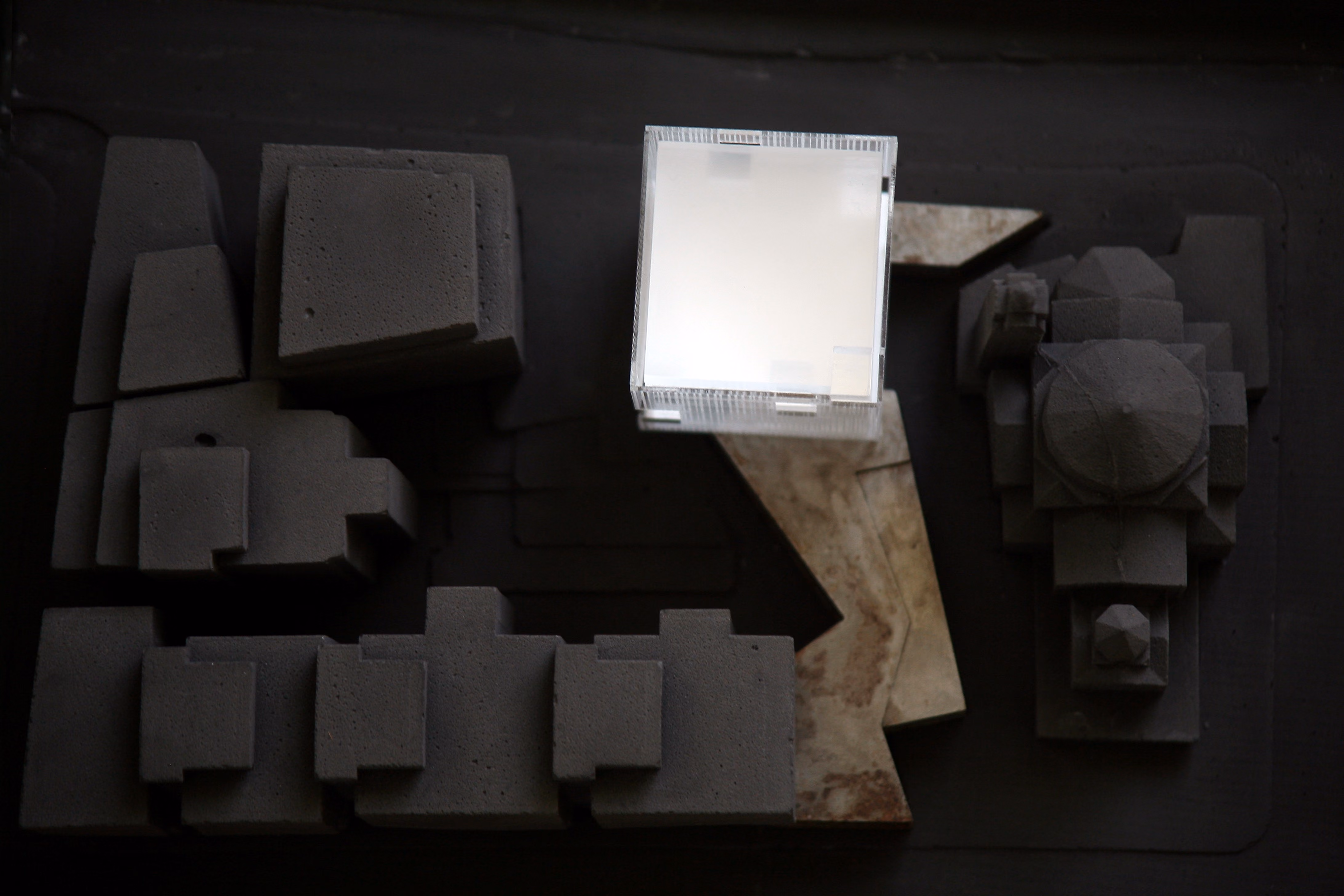 Study model for Saifi 178 in Beirut, grey massing blocks arranged around a glowing white light box representing the courtyard passage