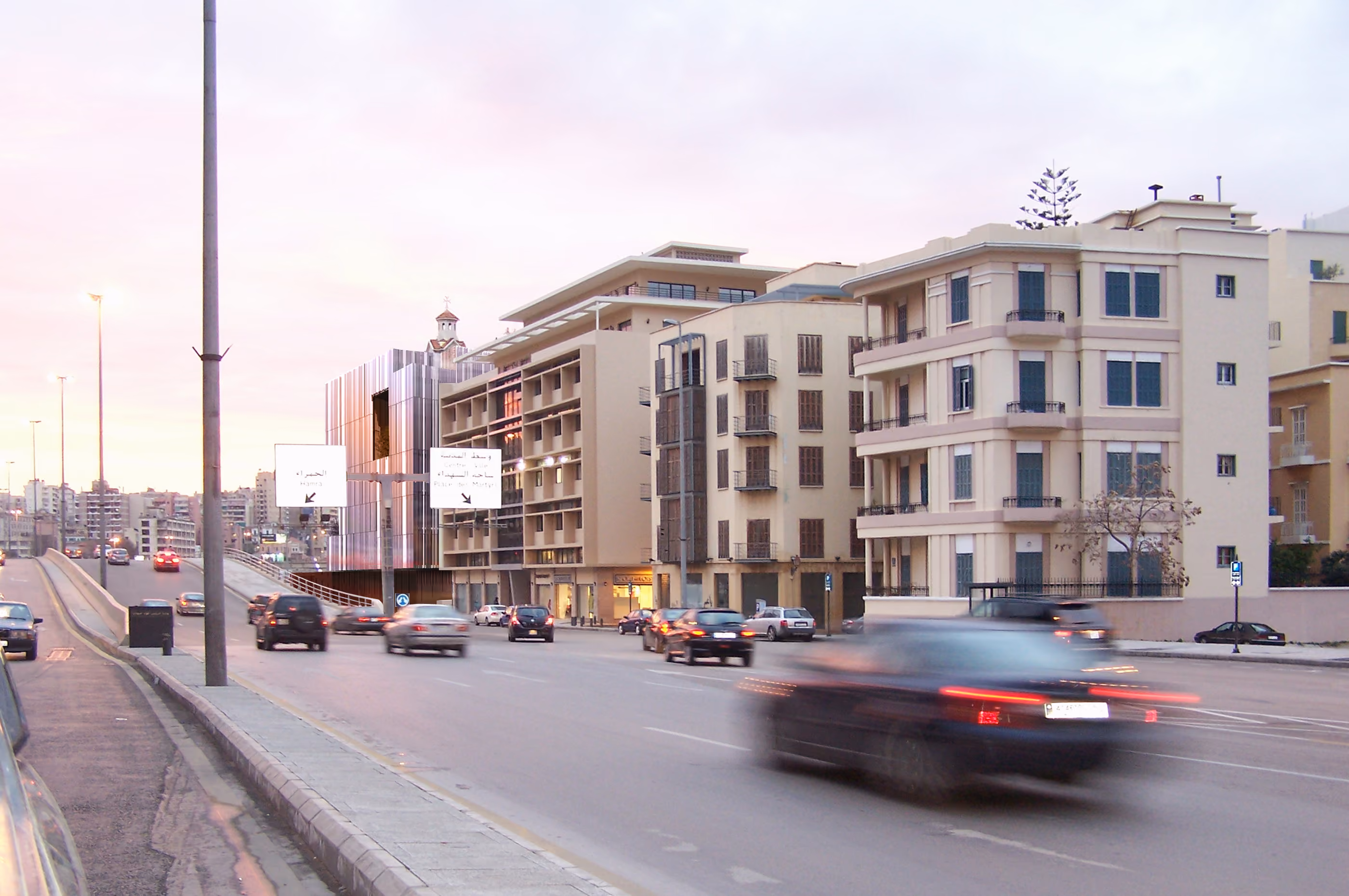 Saifi 178 in Beirut seen from a busy coastal road at dusk, its perforated metal facade standing beside traditional Lebanese apartment buildings with shuttered balconies