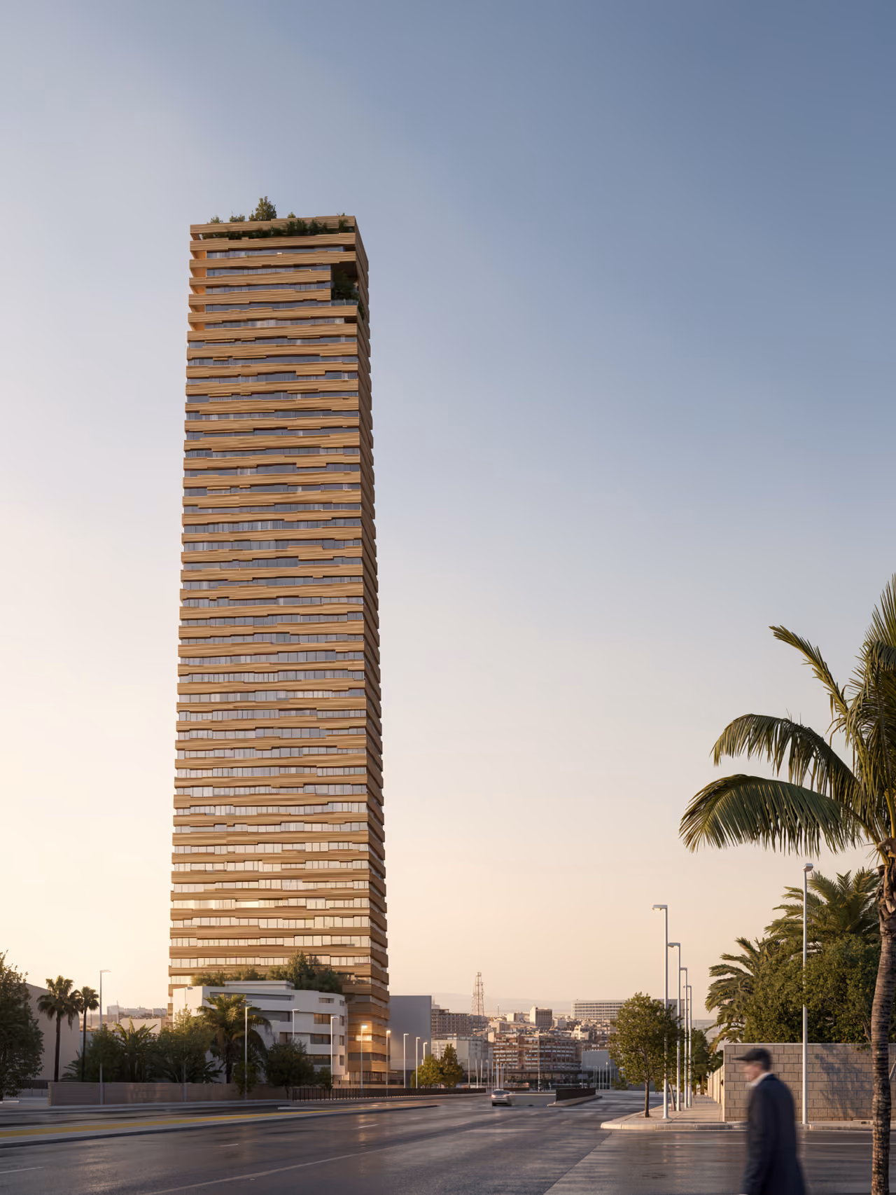 Citadel Tower in Erbil, a slender high-rise with horizontal terracotta-toned banding and stepped balconies, seen from street level with palm trees at dusk