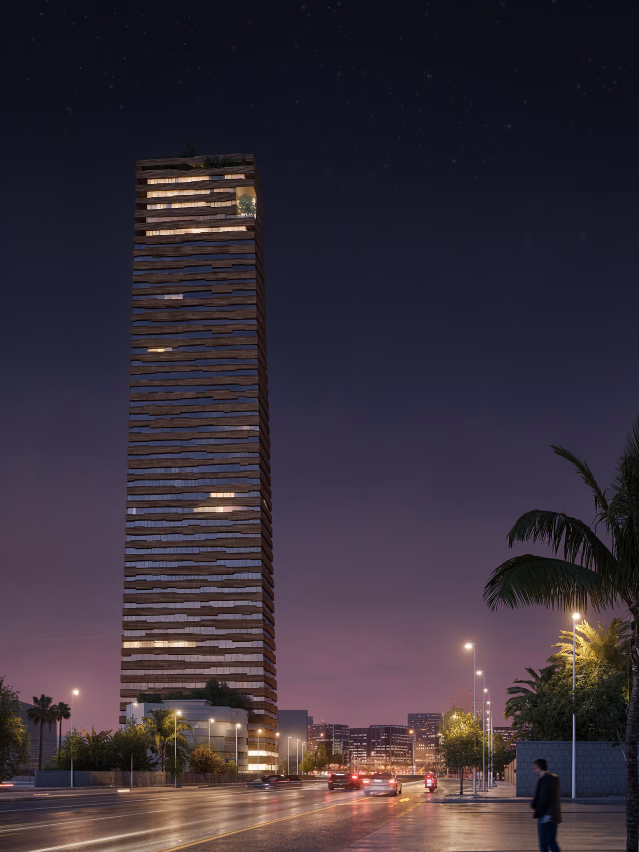 Citadel Tower in Erbil at dusk, its brick-textured striated facade glowing from within, palm-lined street and passing traffic in the foreground
