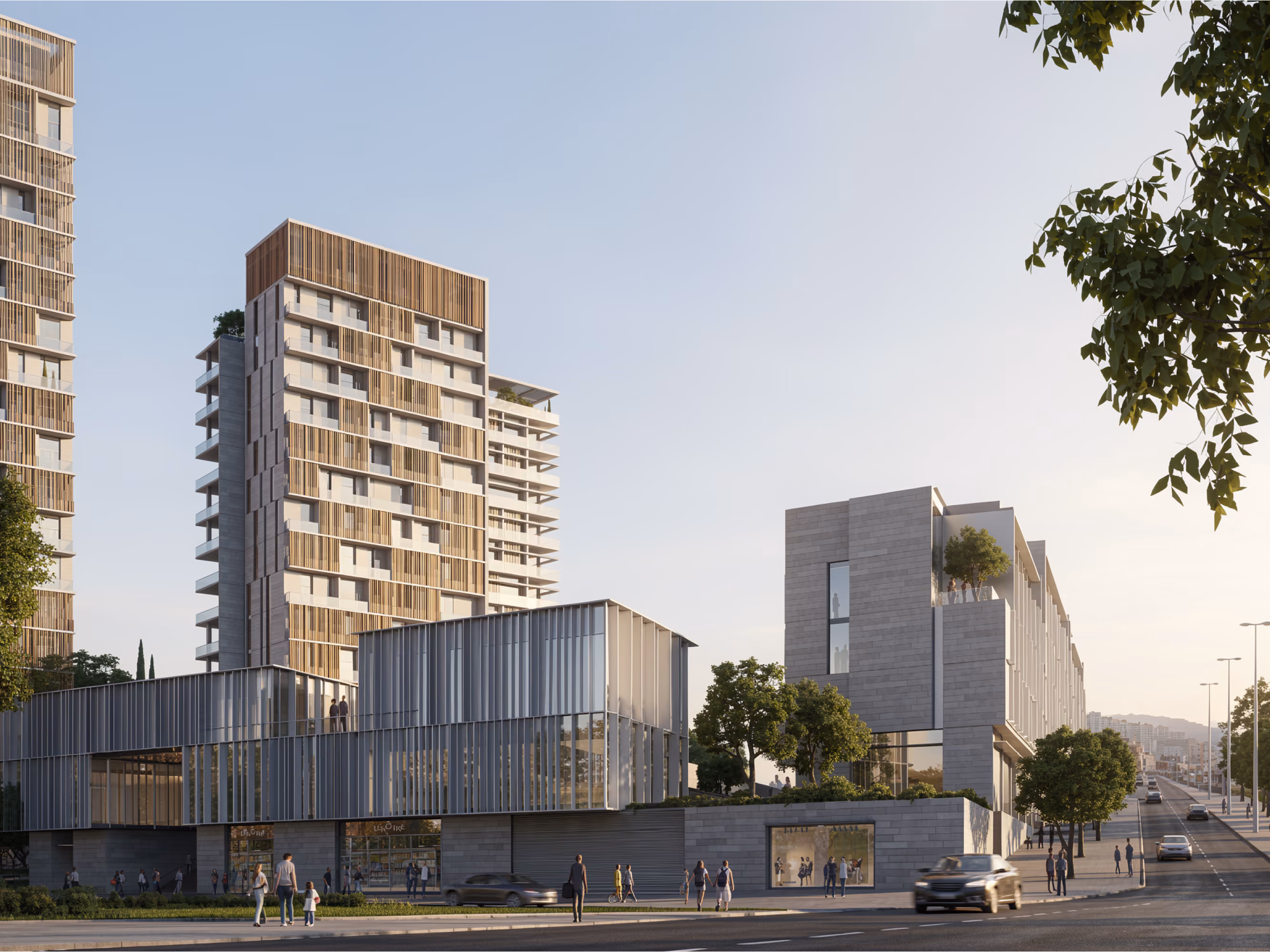 Street-level view of Uptown Park in Hazmieh, timber-clad residential towers behind a glazed retail podium and stone-faced low-rise block along a tree-lined avenue