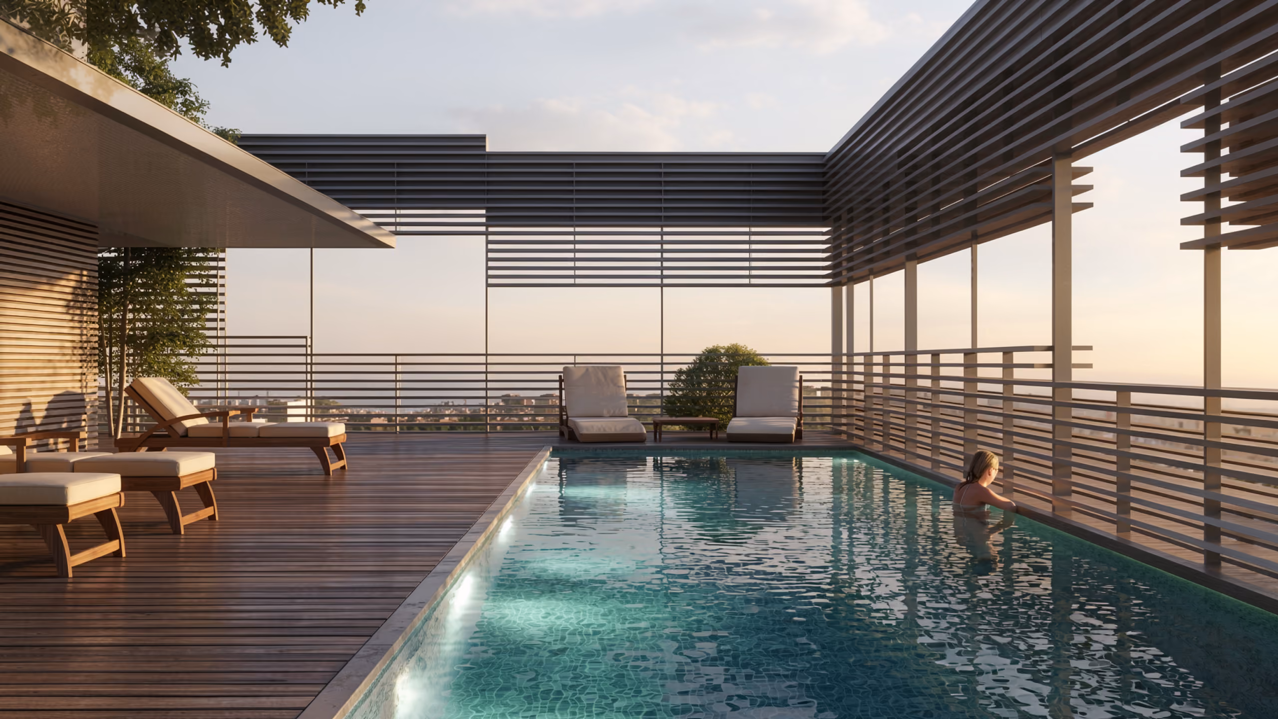 Rooftop pool terrace of Citadel Tower in Erbil, timber decking and lounge chairs beside a lit infinity pool with slatted metal screens at dusk