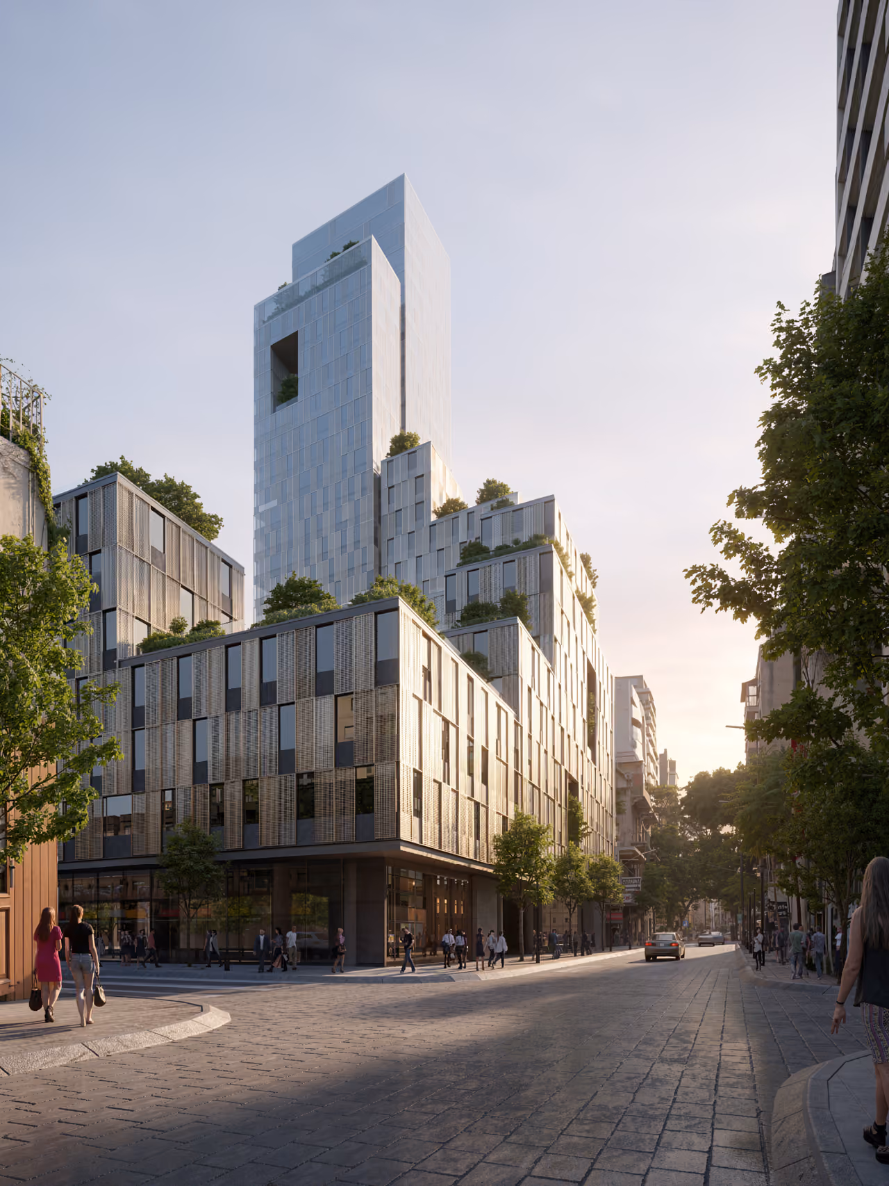 City Campus 01 in Beirut, a stepped high-rise with terraced greenery above a perforated metal-clad podium, seen from a tree-lined street at dusk