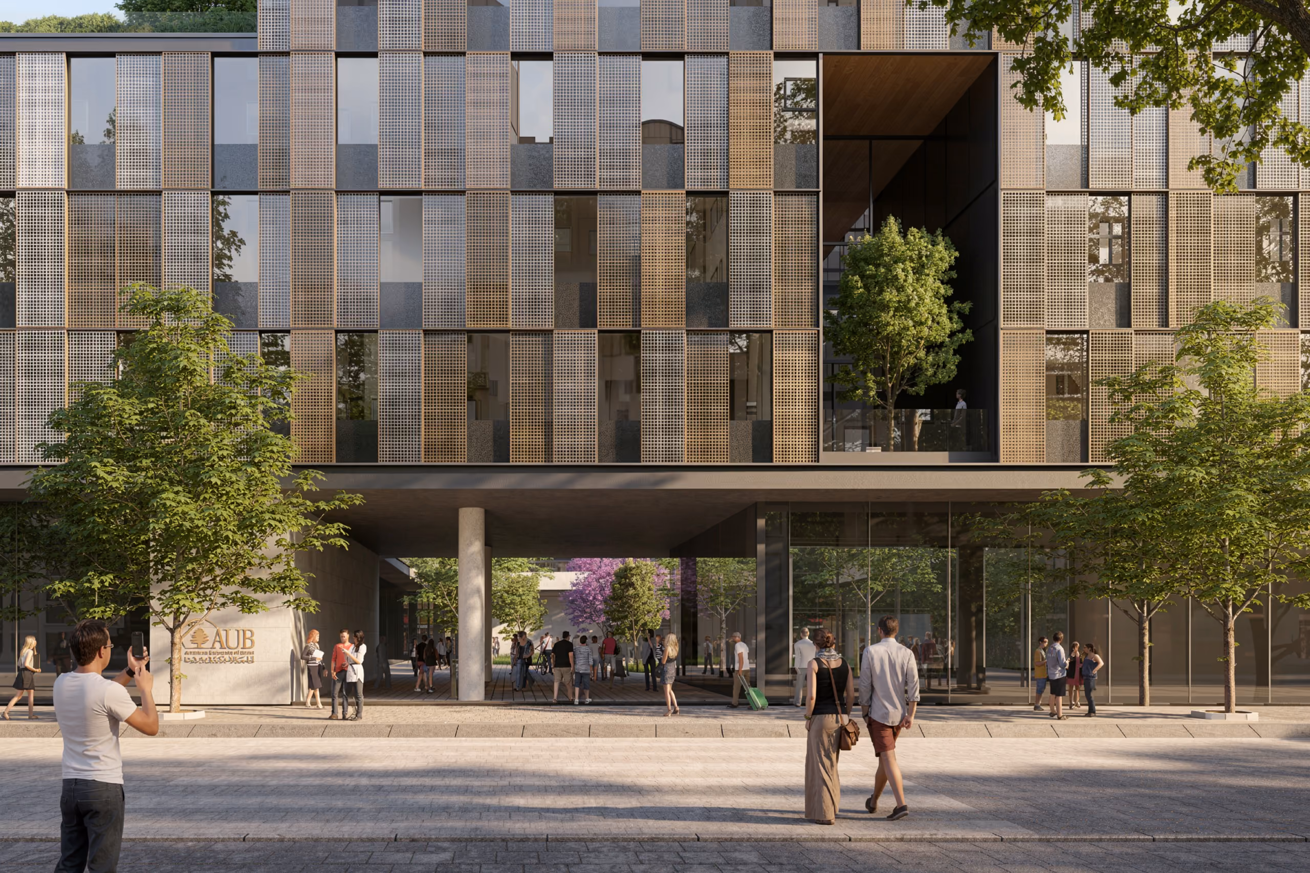 Perforated bronze and grey metal screens wrap City Campus 01 in Beirut, with a raised entrance plaza and glass-fronted ground floor busy with pedestrians