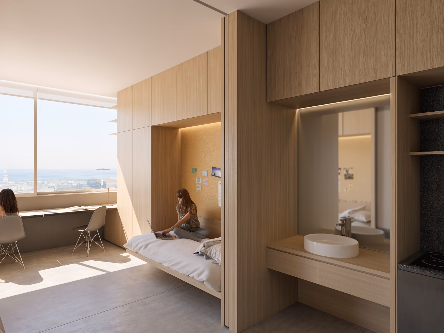 Student dorm room in City Campus 01, Beirut, with wooden built-in bed nook, study desk by a sea-view window, and a compact vanity and kitchenette