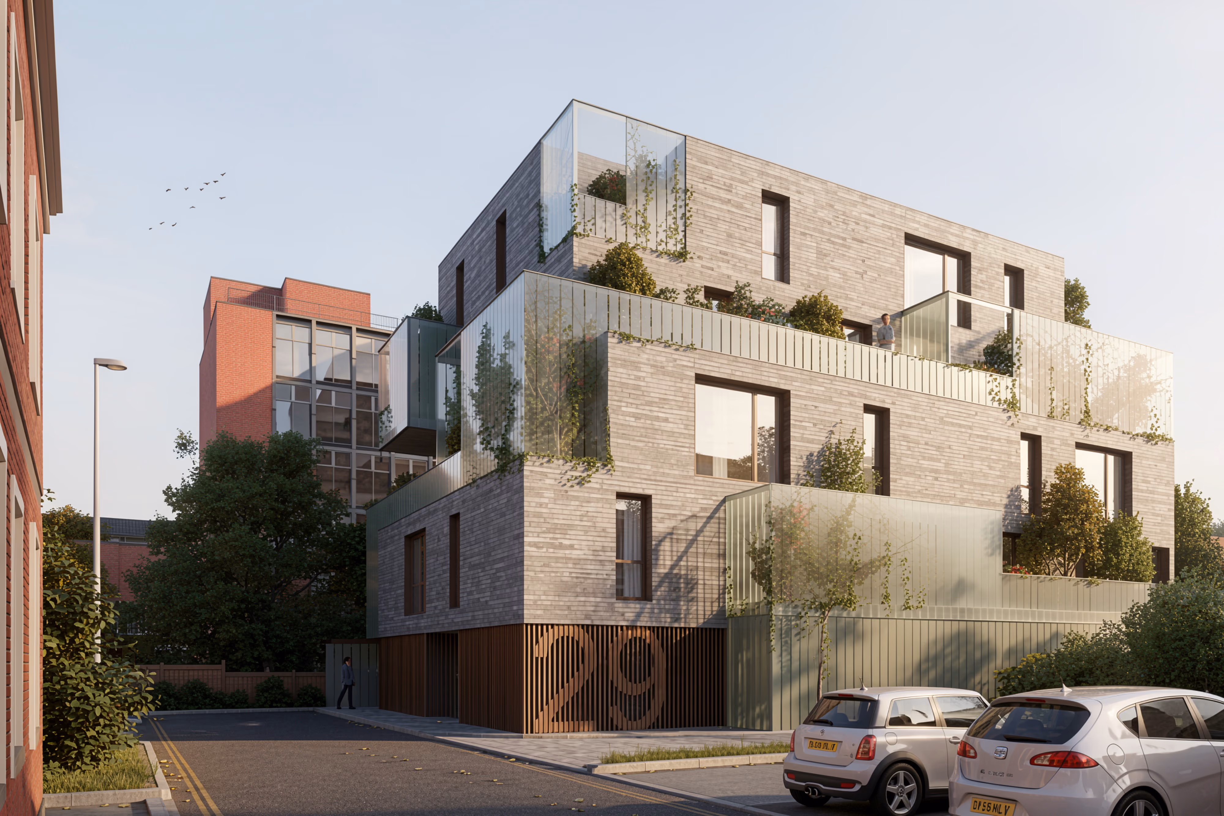 Wicks Place, a stepped brick residential building by Nabil Gholam Architects with terraced gardens and glass balustrades, in a quiet street in Chelmsford, United Kingdom