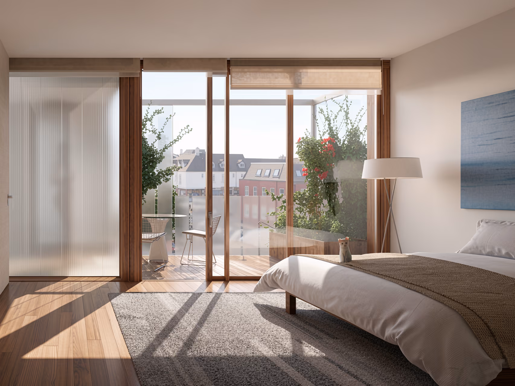 Bedroom interior at Wicks Place in Chelmsford, wood flooring and sliding glass doors opening onto a planted terrace with rooftop views
