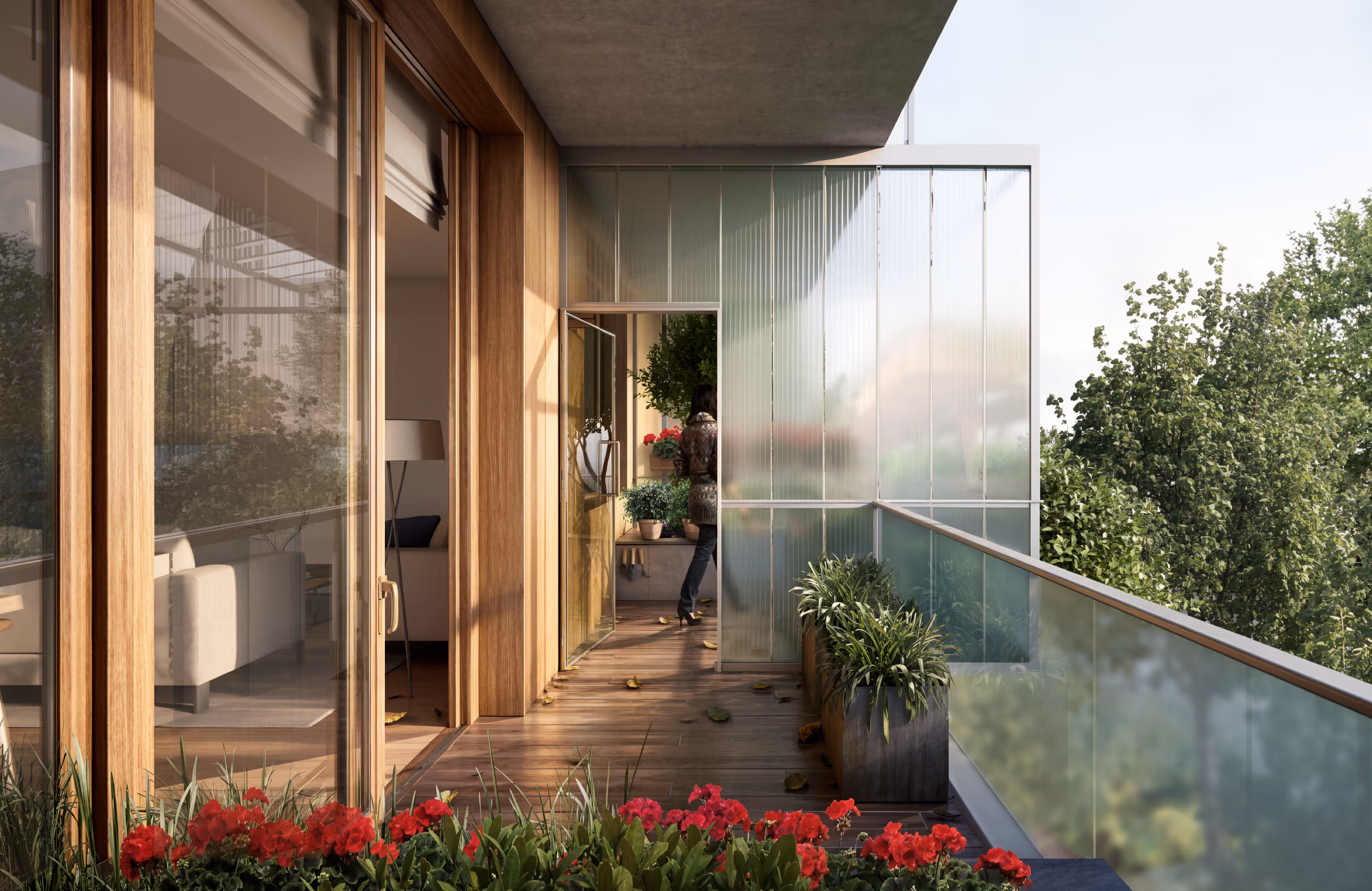 Balcony at Parkway Road in Chelmsford with timber-framed glass doors, wooden decking, red flowering plants and a fluted glass privacy screen overlooking trees