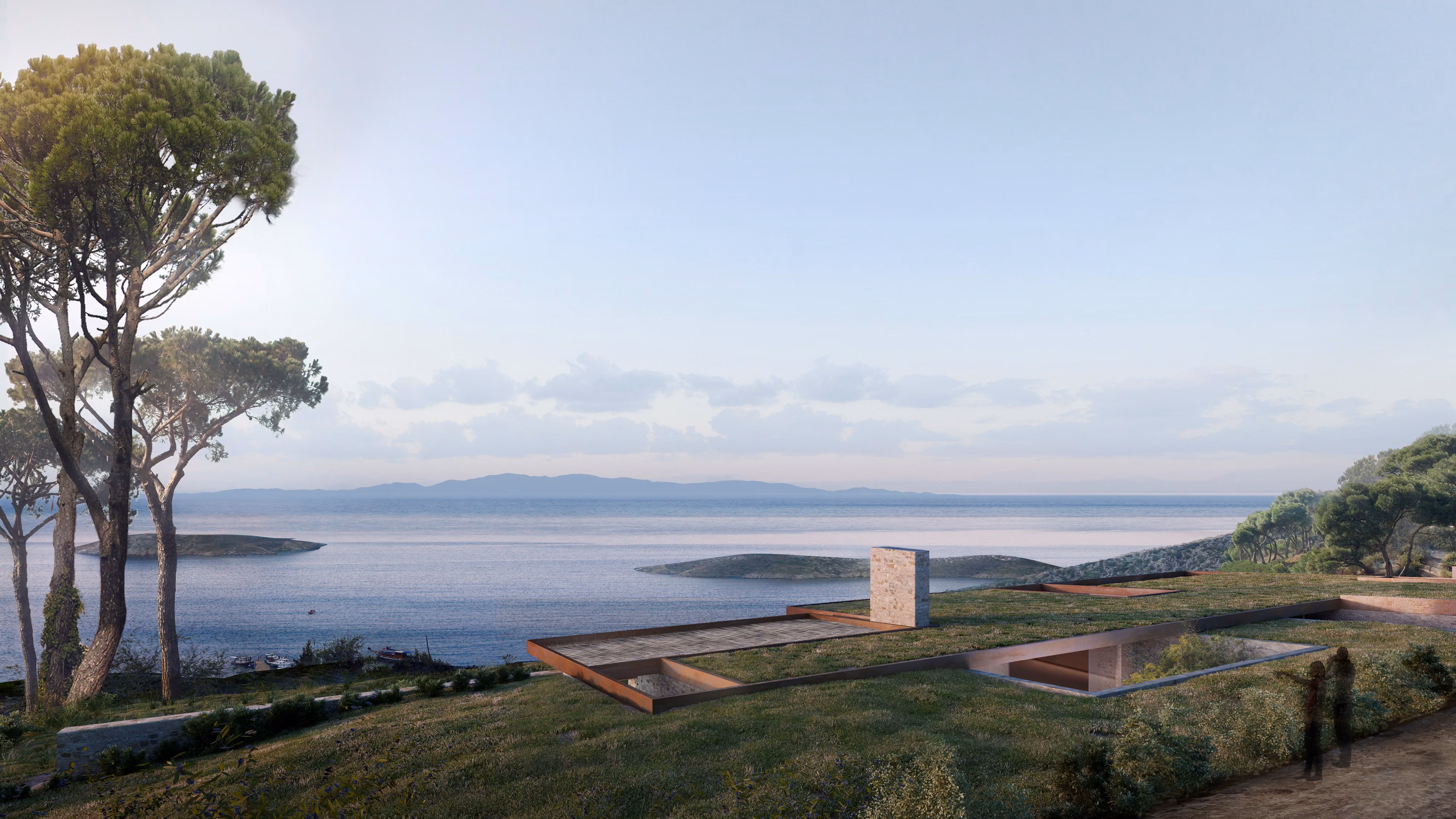 Low-lying stone and timber pavilions of Almost Invisible Resort in Bodrum set into a grassy hillside overlooking the Mediterranean and islands