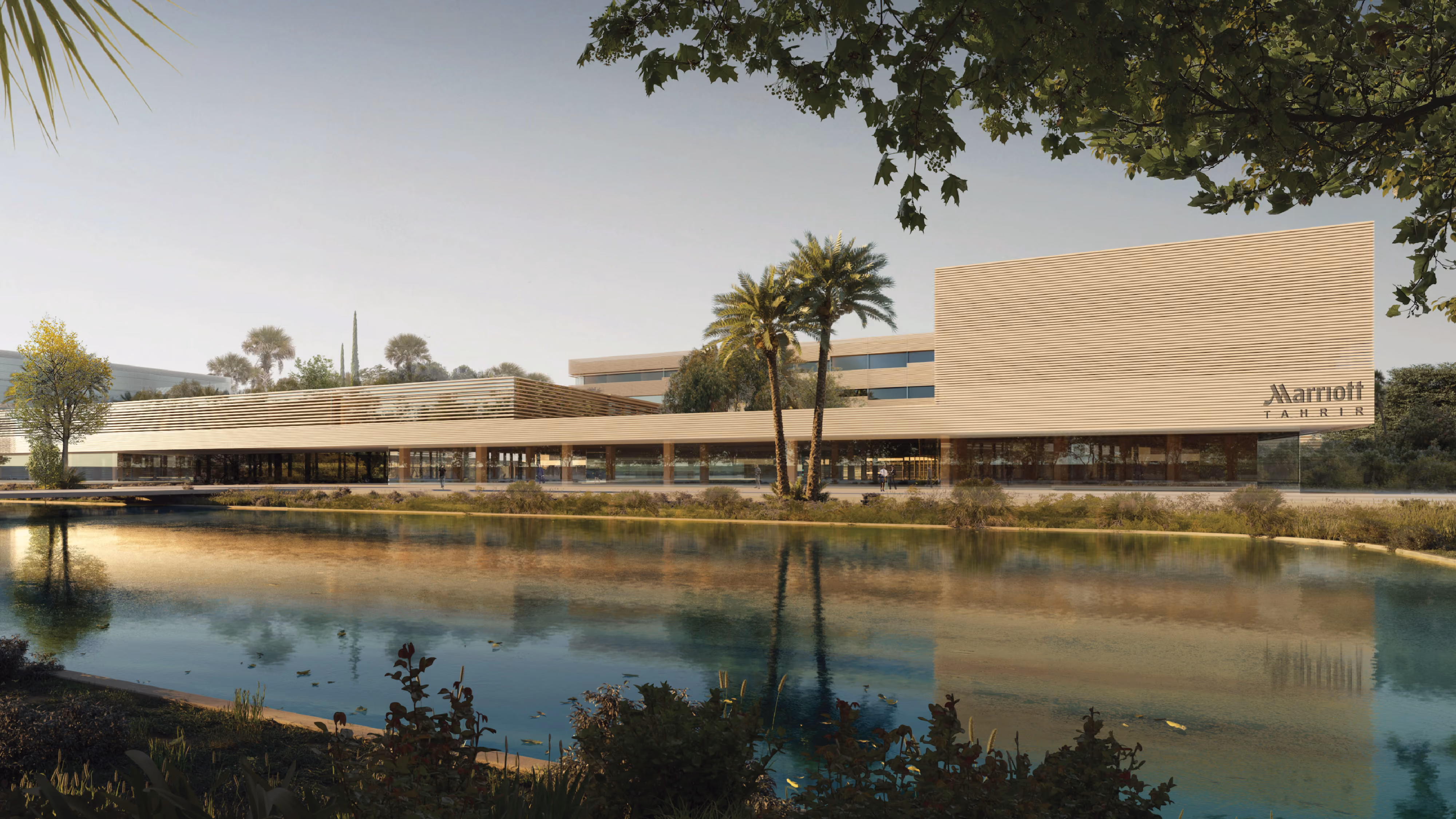 Marriott Tahrir building within the Industrial Campus in Ain El Sokhna, timber-slatted facade fronting a reflecting lagoon lined with palm trees