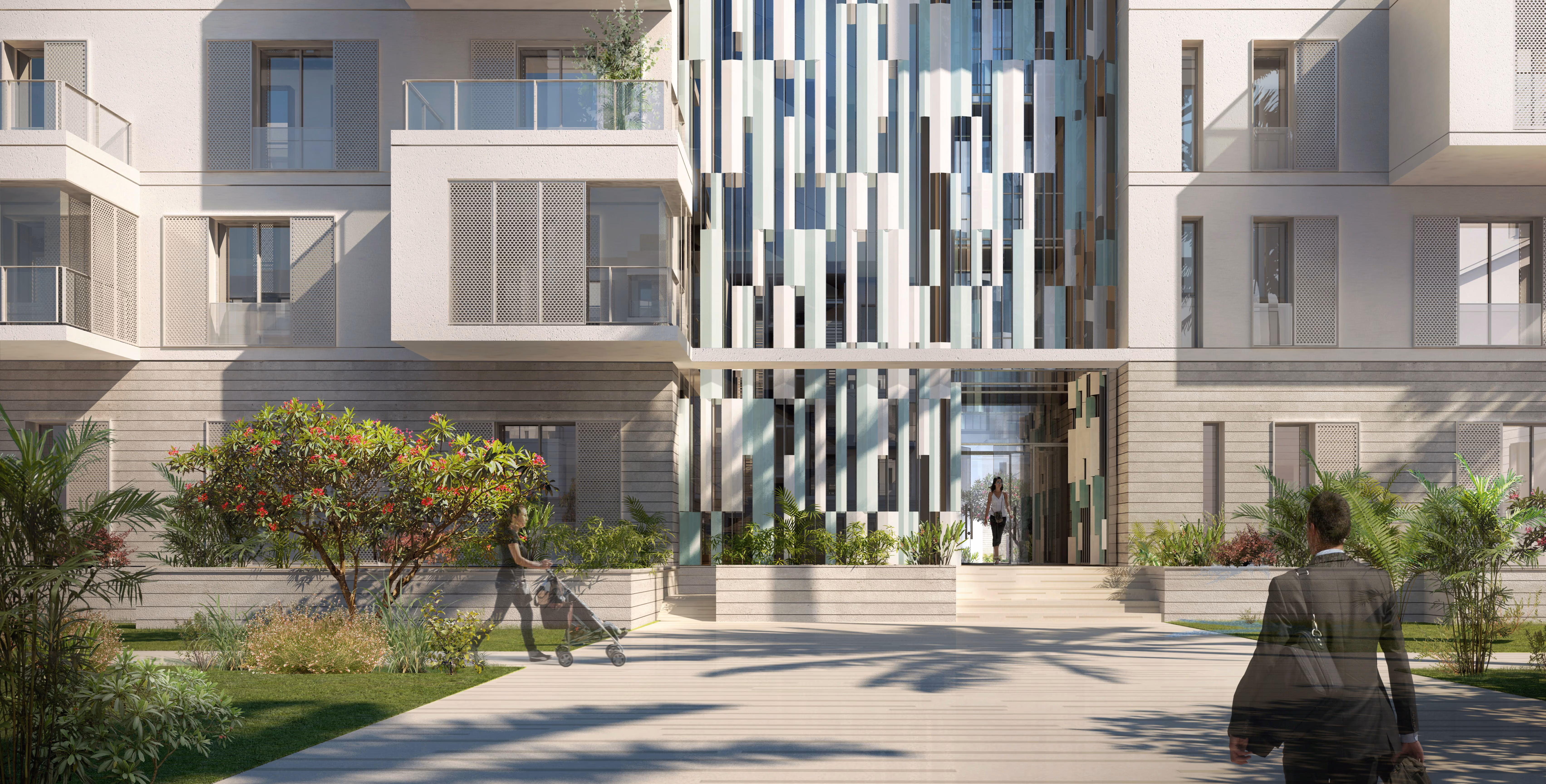 Courtyard entrance at Esplanade Eastown in Cairo, residential blocks with perforated screens framing a vertical glazed atrium, landscaped walkway with pedestrians