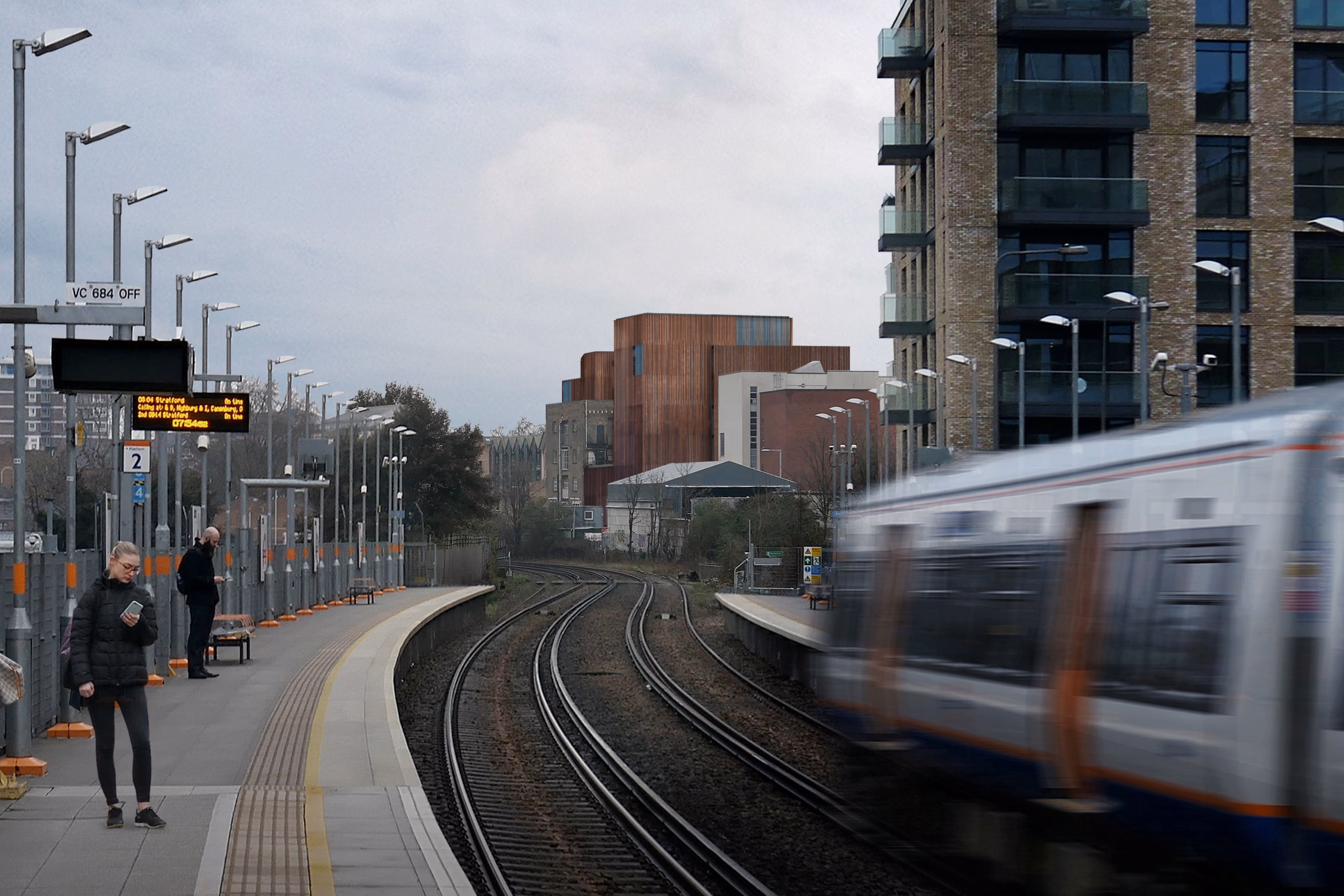 78-89 Lots Road by Nabil Gholam Architects, its timber-clad volumes rising beyond a railway platform and tracks in Chelsea, London, United Kingdom