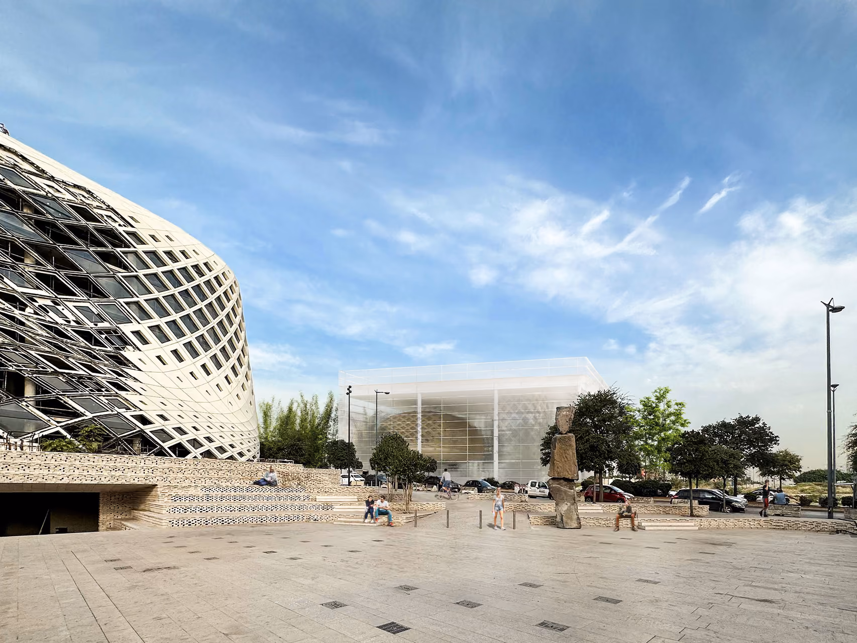 Public plaza at Art Hub in Beirut, tiered stone steps and a stone sculpture leading toward the woven lattice facade of the perforated building and a glass pavilion beyond