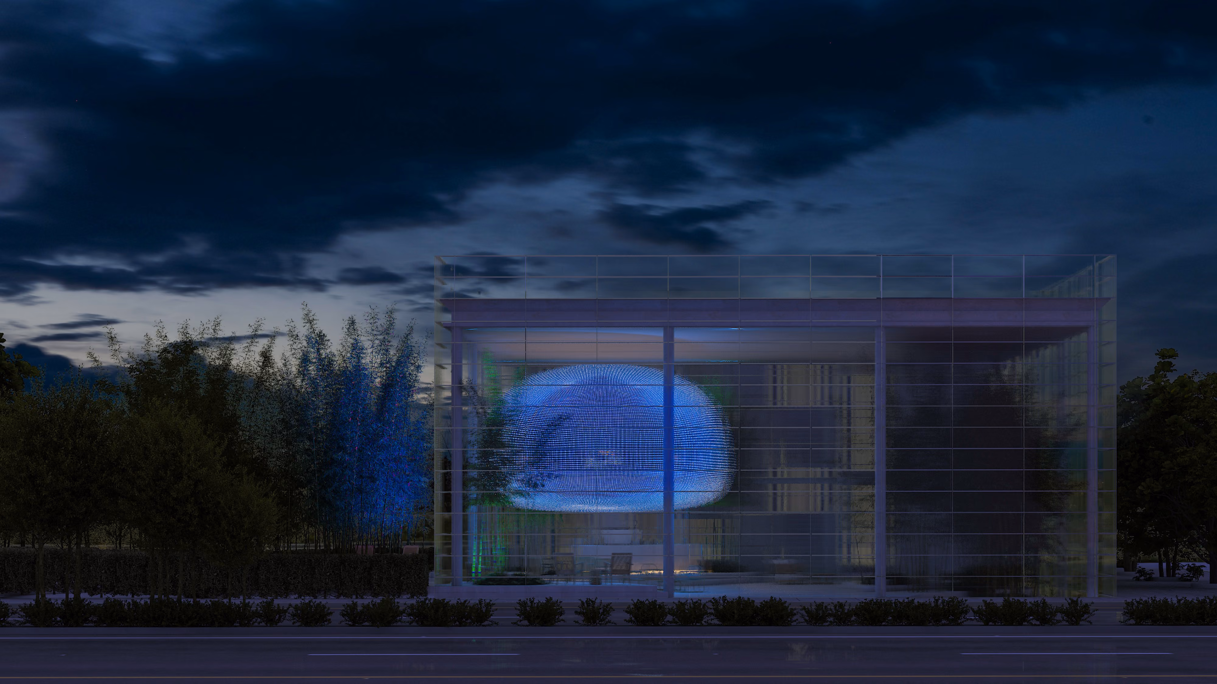 Art Hub, a glass mixed-use pavilion by Nabil Gholam Architects in Beirut, Lebanon, its illuminated cocoon-shaped display glowing blue at dusk amid bamboo landscaping