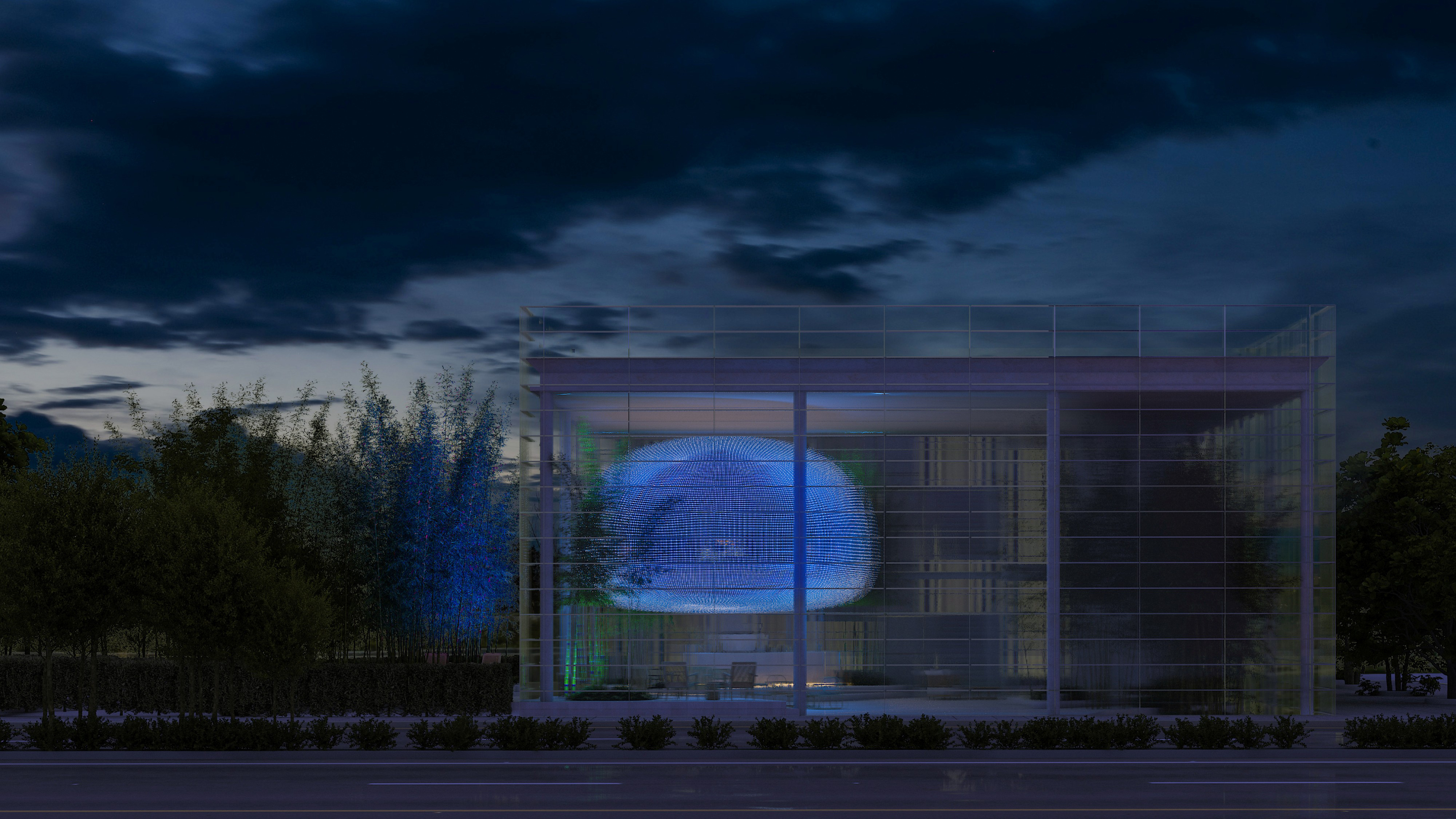 Art Hub, a glass mixed-use pavilion by Nabil Gholam Architects in Beirut, Lebanon, its illuminated cocoon-shaped display glowing blue at dusk amid bamboo landscaping