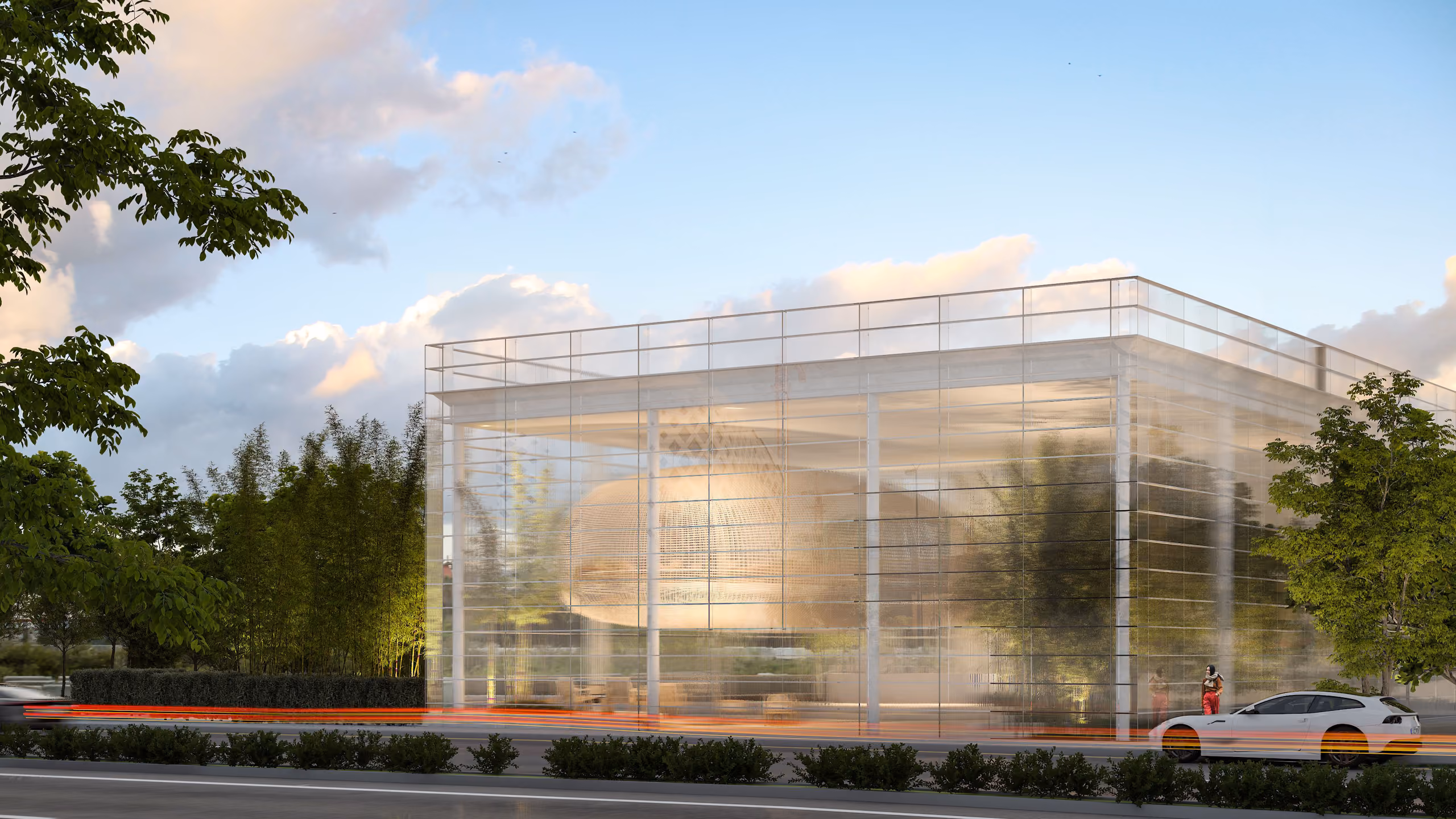 Art Hub in Beirut, glass-enclosed pavilion with a woven cocoon-shaped display pod visible inside, surrounded by bamboo and trees at dusk