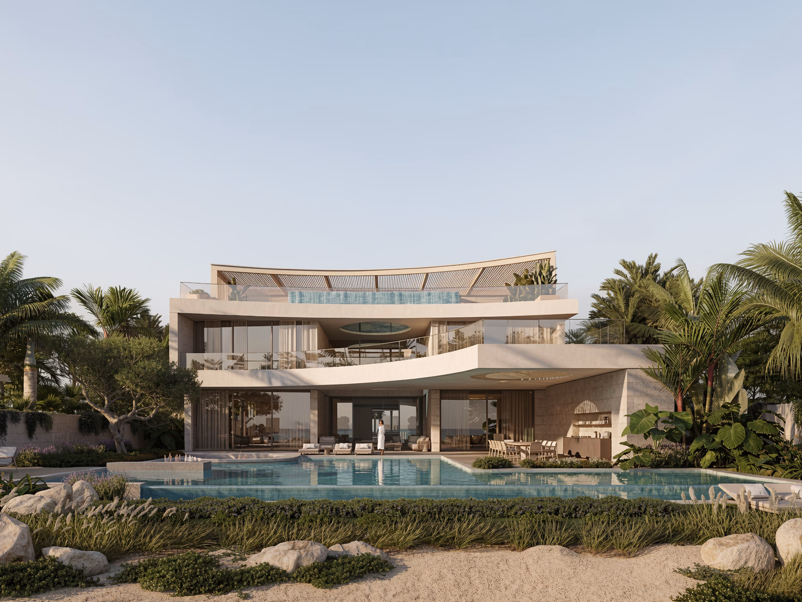 MV 33 villa in Dubai, curved stone terraces stacked above an infinity pool, framed by palm trees and rock landscaping at dusk