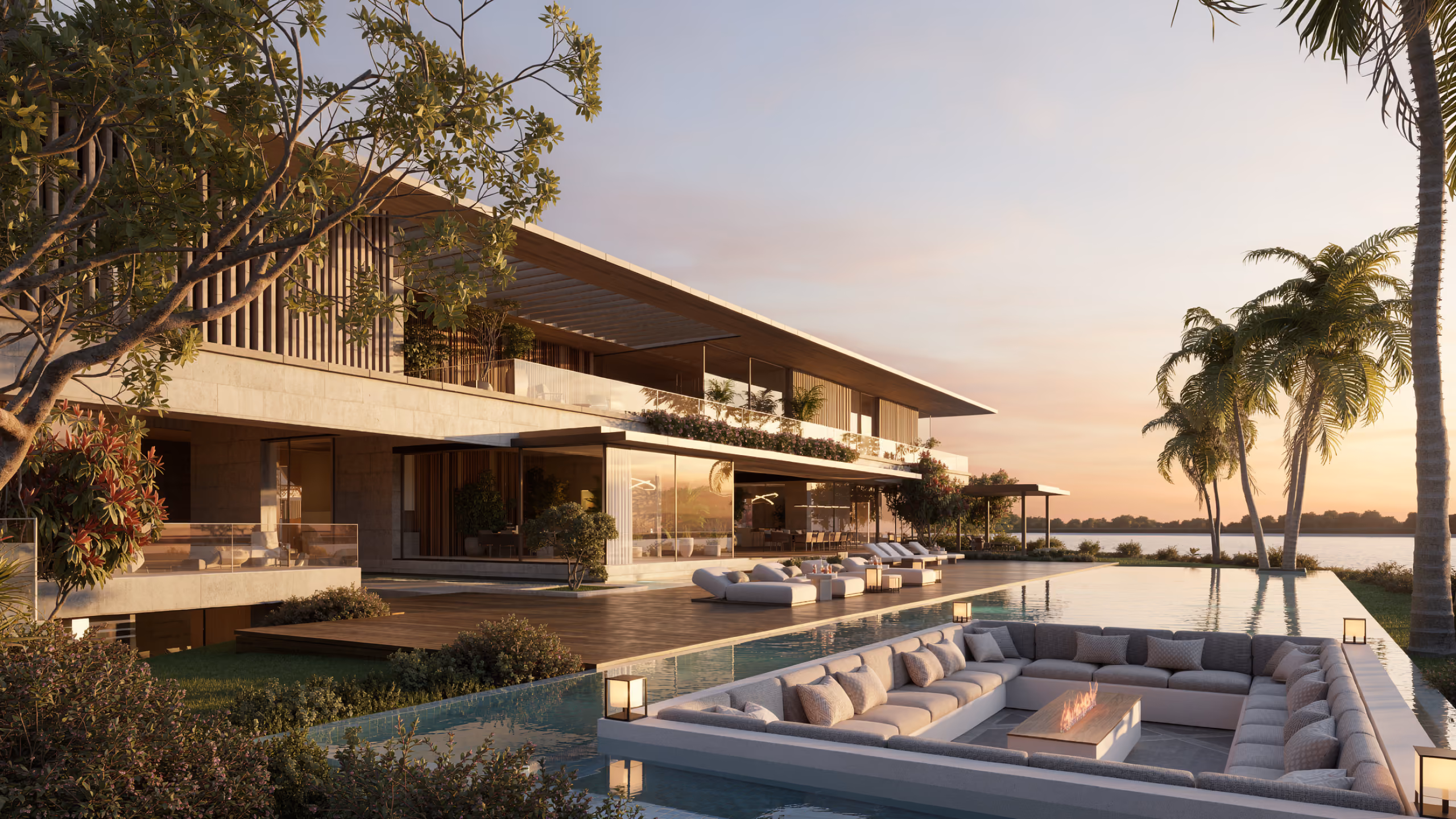 Lagoon Mansion in Dubai, waterfront terrace with infinity pool, sunken lounge with fire pit and palm trees at dusk