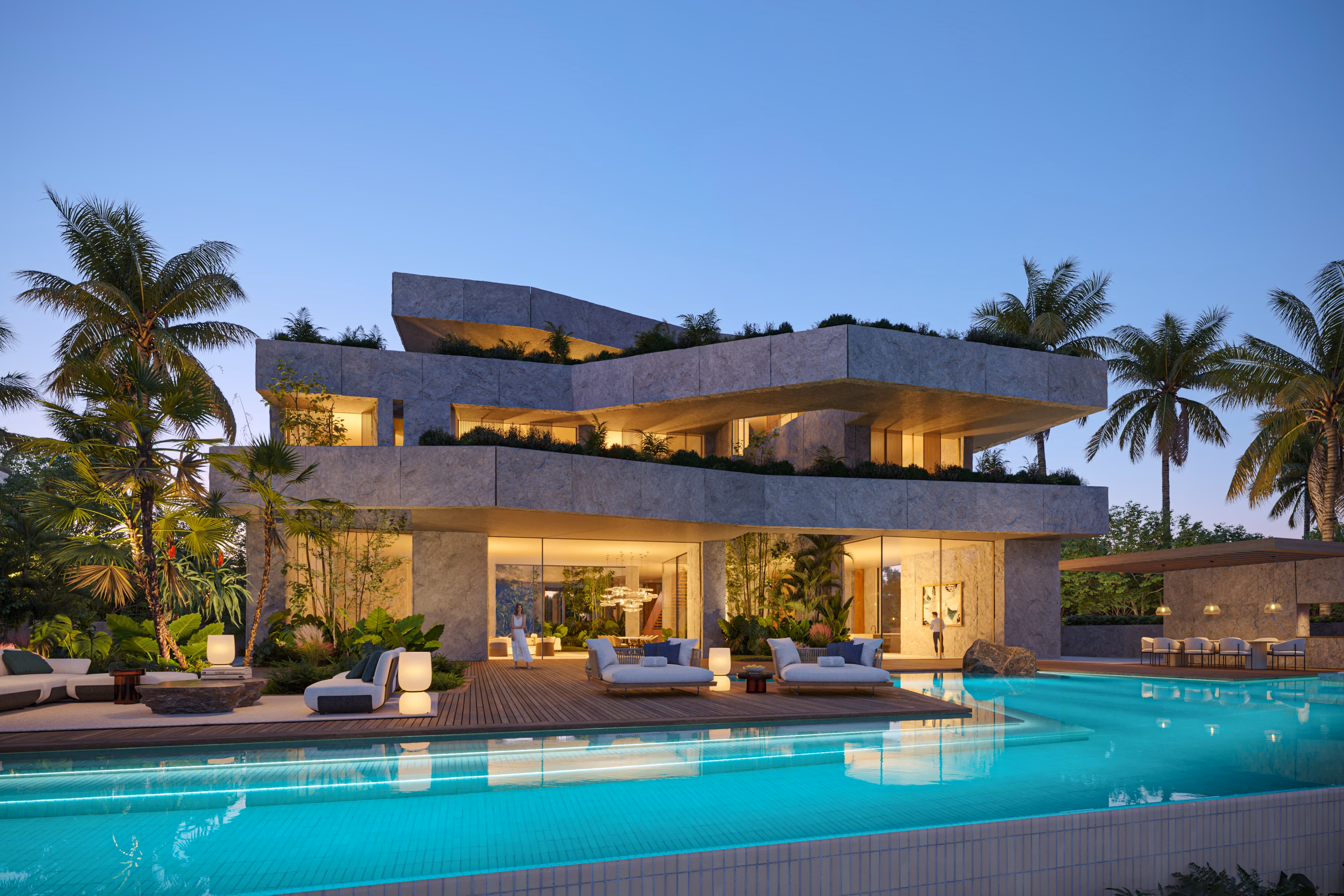 Geode, a crystalline stone-clad villa by Nabil Gholam Architects, with layered angular volumes overlooking a lit pool and palm-lined terrace at dusk in Dubai, United Arab Emirates