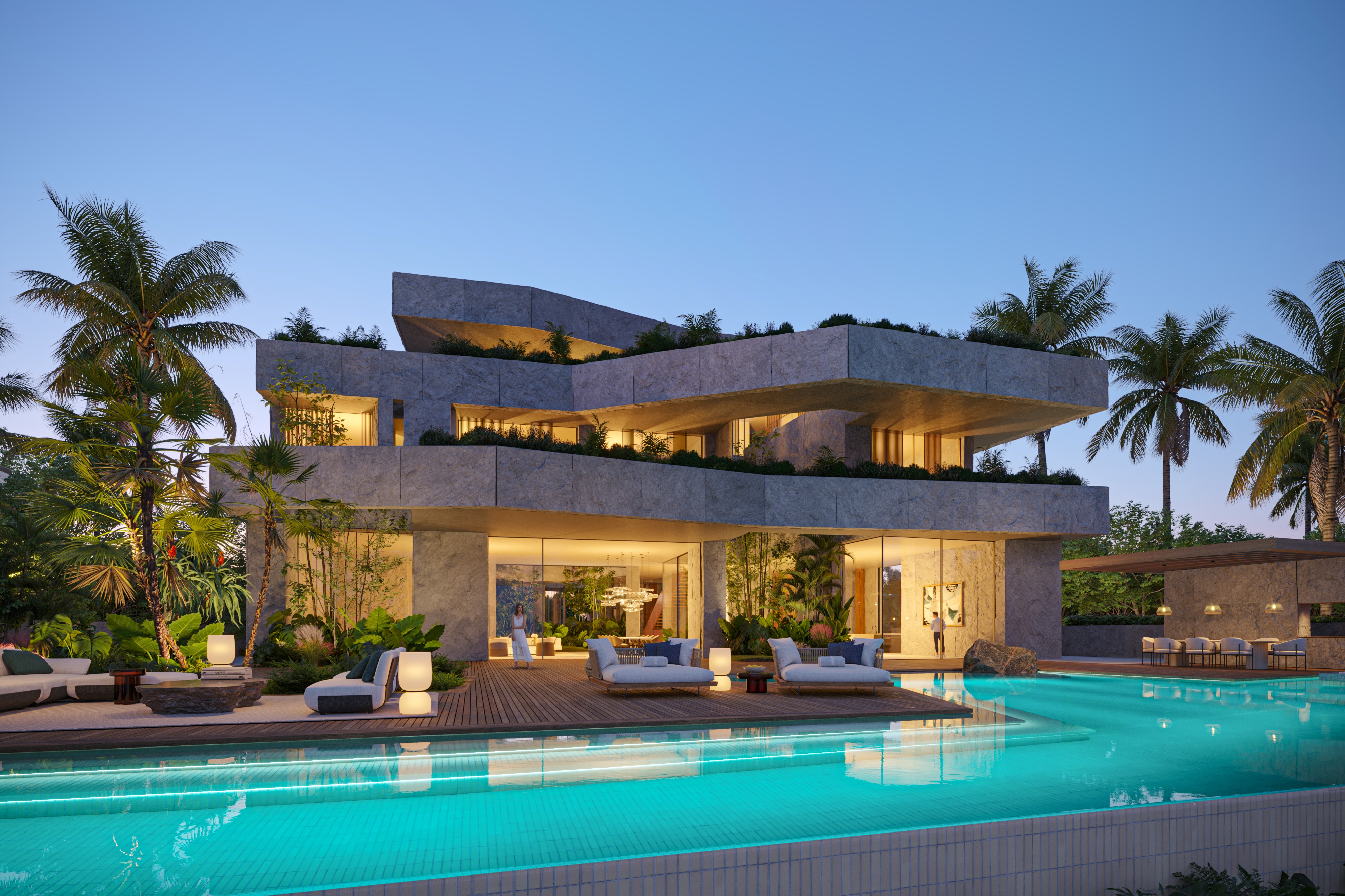 Geode, a crystalline stone-clad villa by Nabil Gholam Architects, with layered angular volumes overlooking a lit pool and palm-lined terrace at dusk in Dubai, United Arab Emirates